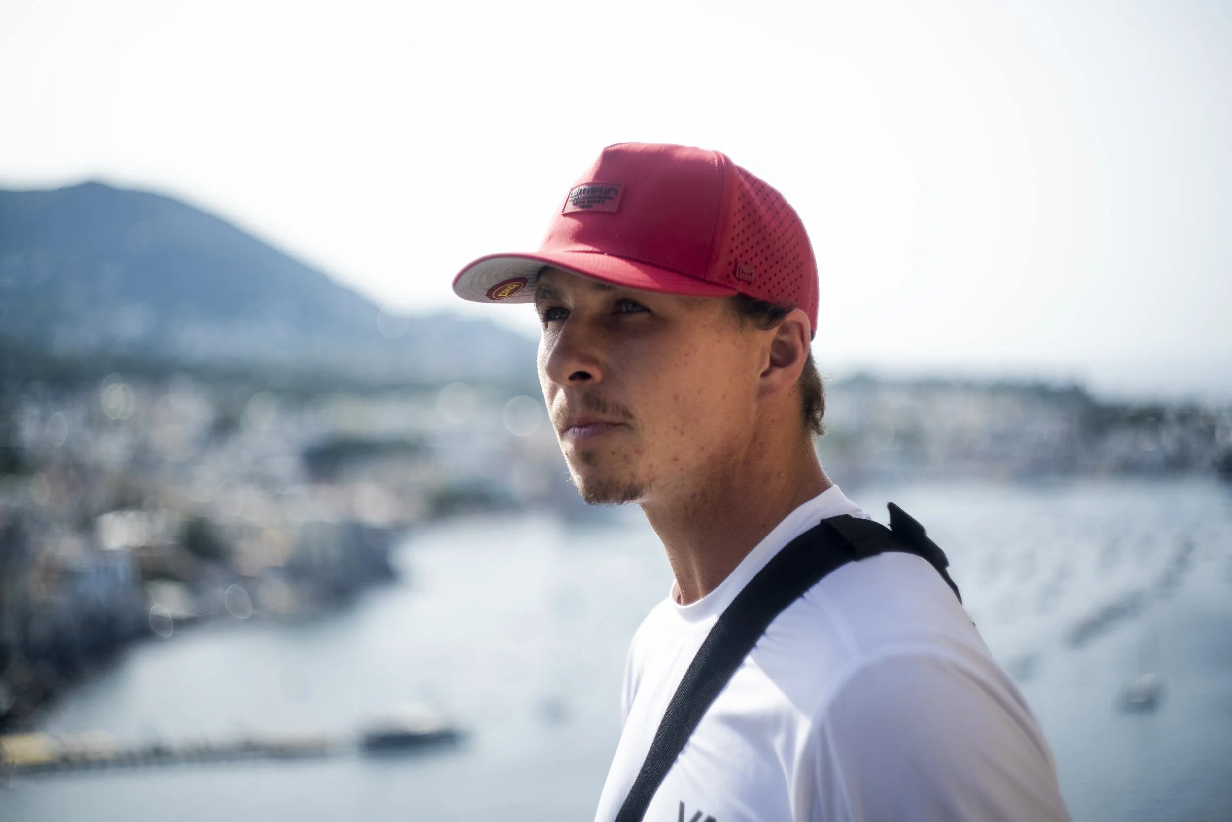 Man in red cap overlooking a coastal landscape