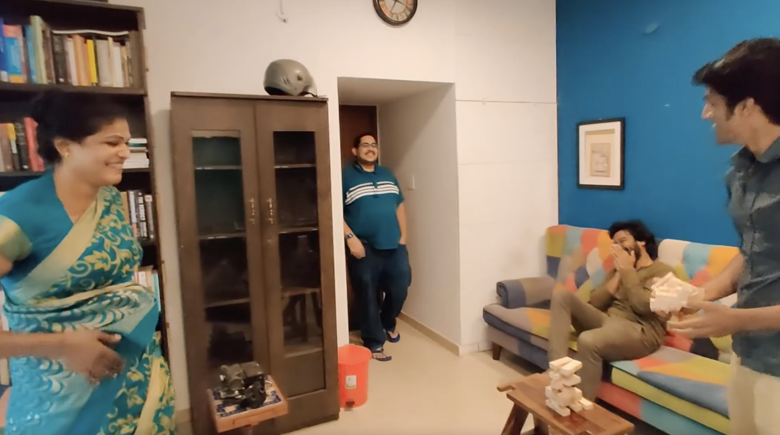 4 members of our team, all laughing while playing Jenga. The Jenga set has just fallen, and everyone is in splits due to the sudden toppling of the Jenga blocks!