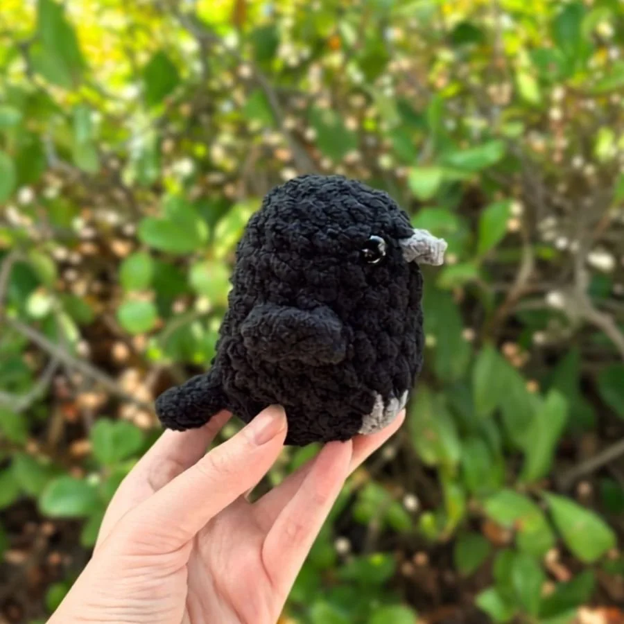 little crochet crow or raven held by a hand - no sew crochet bird - free crochet raven or crow pattern