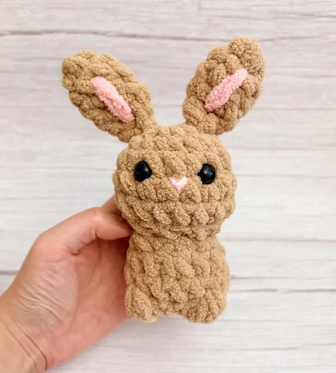 tiny crochet brown rabbit held by hand - free crochet bunny pattern