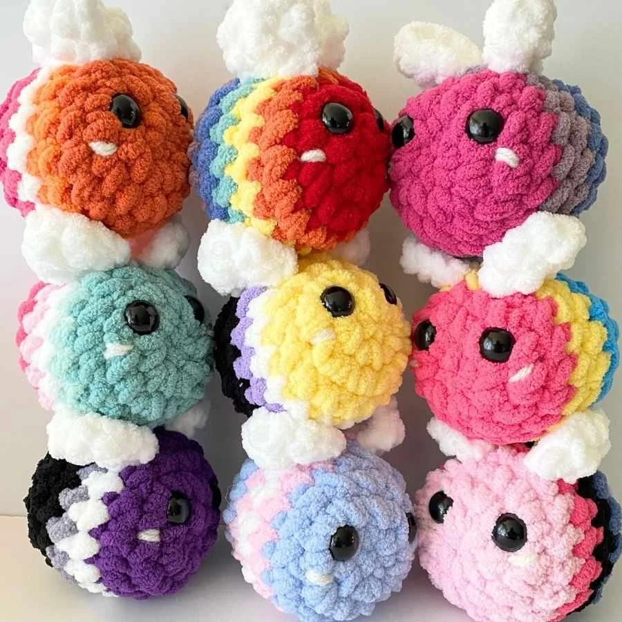 free amigurumi pride bee pattern with crochet bees based on the lgbtq+ pride flags including lesbian pride, rainbow, bisexual pride, abrosexual pride, non-binary pride, pansexual pride, asexual pride, transgender, pride, and omnisexual pride