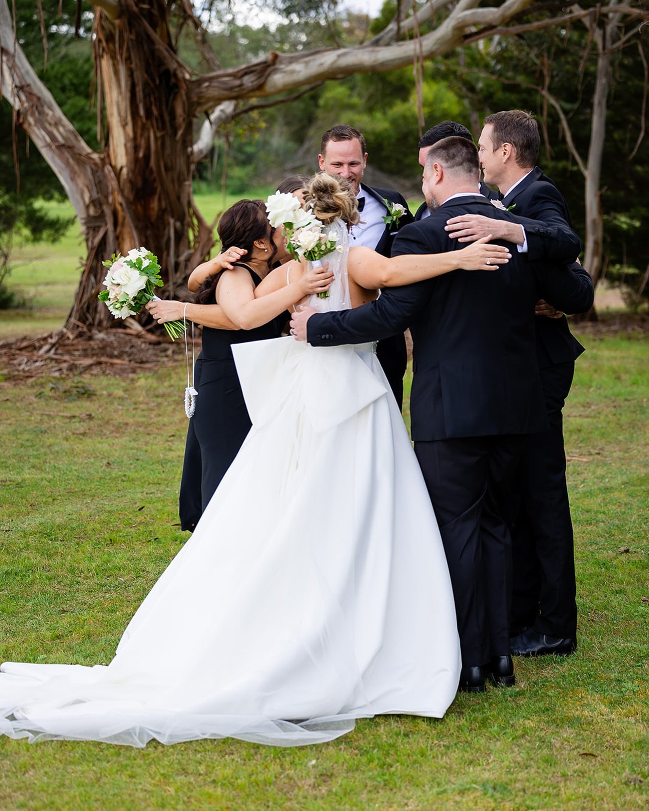 LOVE SCRUM. A post ceremony cuddle with their wedding party, captured by @jesswhitephotography. 
.
I wont leave you hanging at the end of the aisle after the recessional- promise! As soon as the tog has the jubilant aisle shots I&rsquo;ll start sendi
