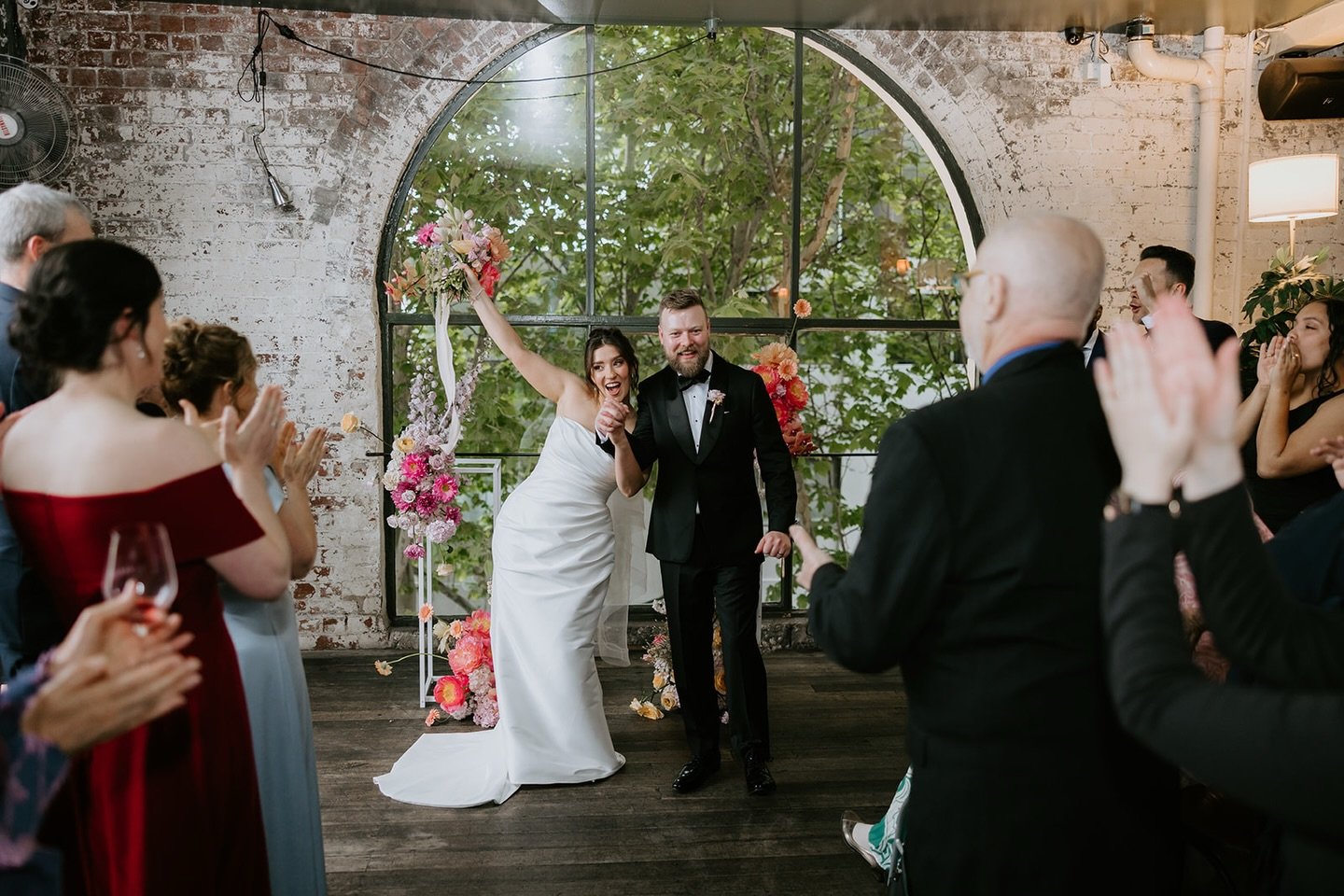 Make some noiiiise for the newlyweds! The BEST feeling captured in photo. All the &lsquo;hard&rsquo; stuff is done, it was actually fun annnd you are MARRIED. Time to rock the recessional! 
.
@danbrannanphoto
@thepanamadiningroom
@heyjack_co / @inbea