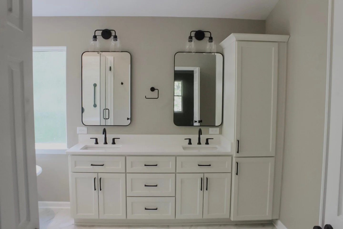This Matthews bathroom came together with crisp white cabinetry, matte black hardware, and soft neutral walls for a look that feels both modern and inviting. Every detail was designed to keep the space feeling bright and elevated🤍 🚿 

#BathroomDesi