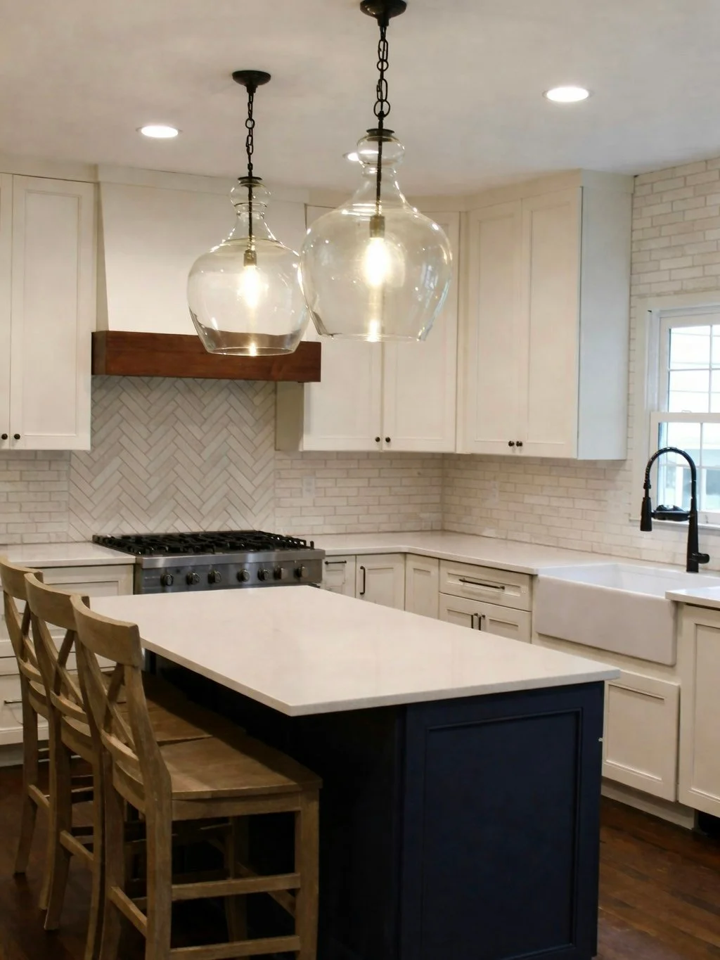 Crisp white cabinetry paired with a deep blue island creates the perfect balance of classic and bold. Warm wood tones and statement lighting add depth and charm, making this Lake Norman kitchen both inviting and effortlessly stylish 🤍 💡 

#Culinary