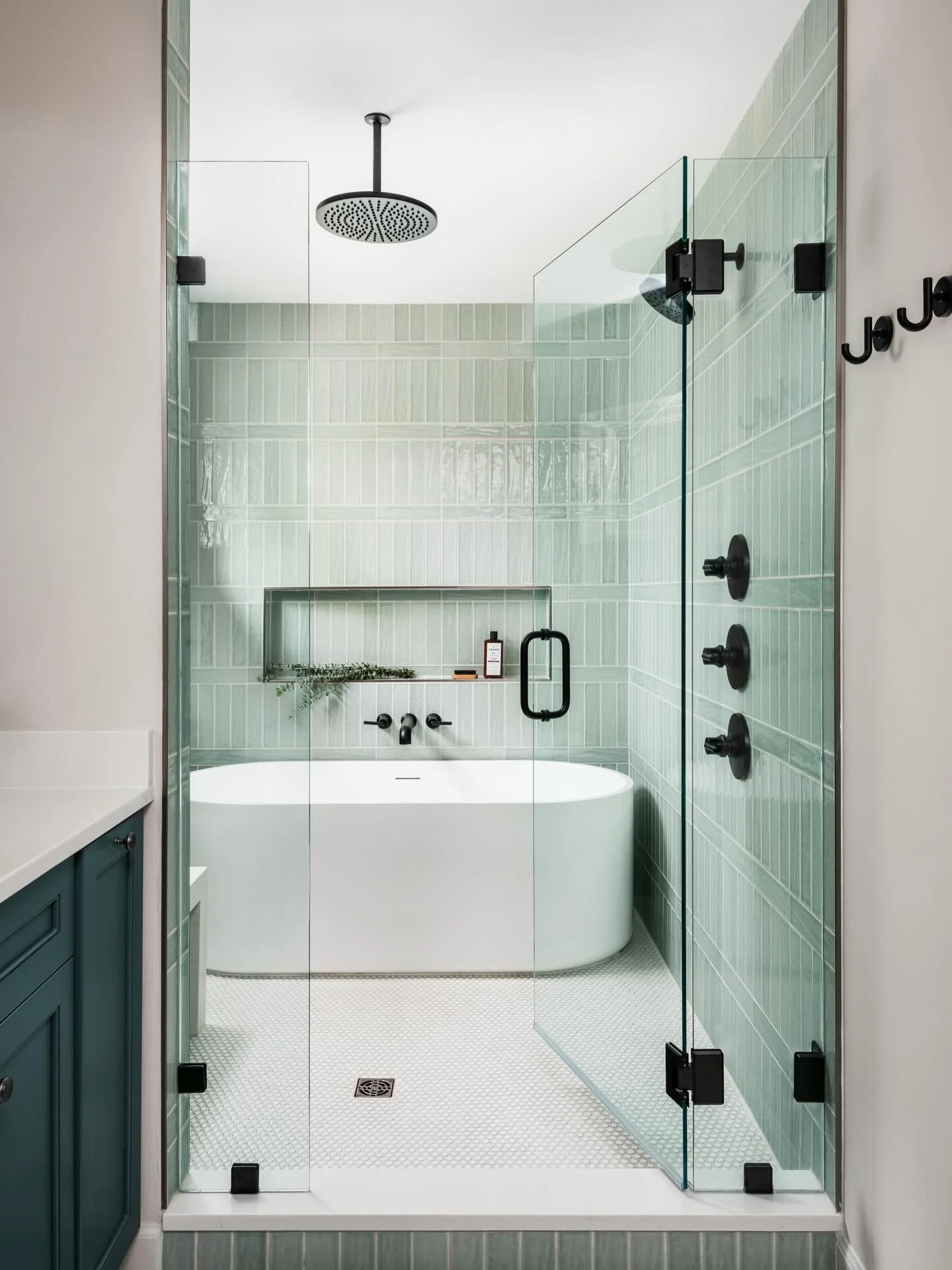 Soft green tones, layered textures, and a luminous glaze finish come together to create a shower that feels timeless and quite luxurious. 
This Montford bathroom was designed to feel calm, elevated, and effortlessly refined. Every material adds softn