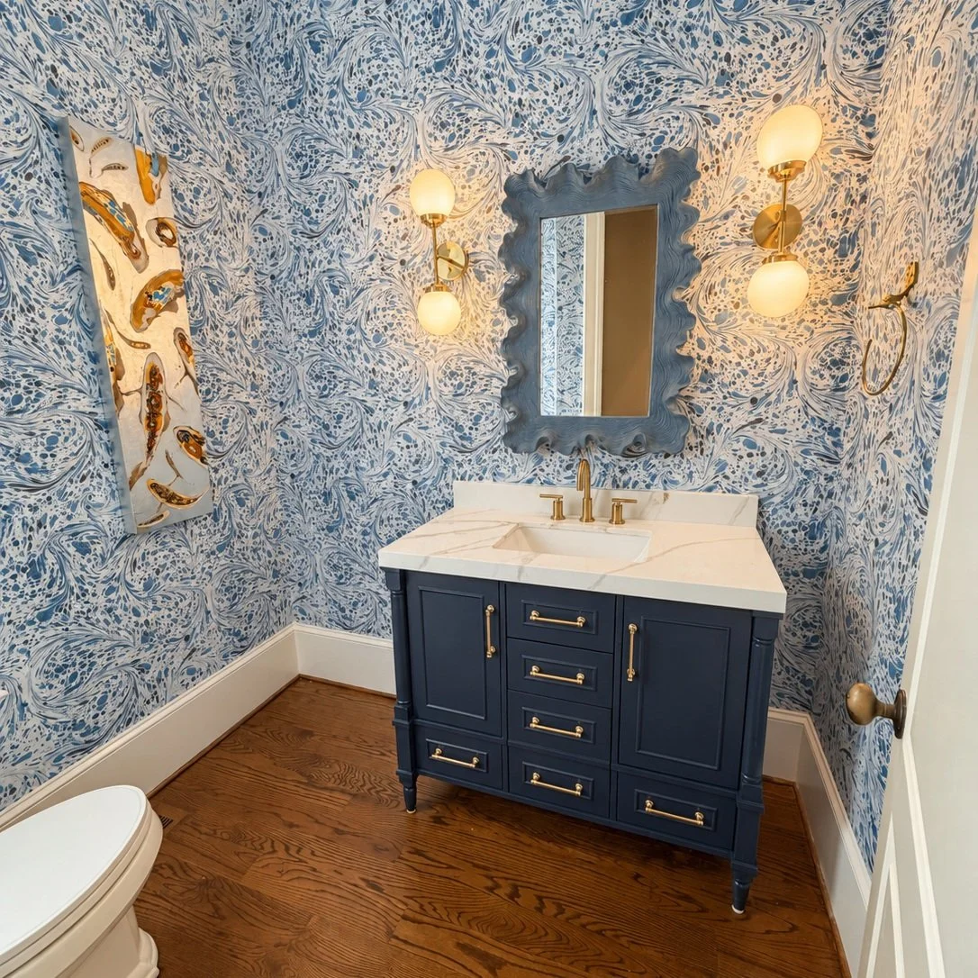 A powder room with personality!

Bold blue wallpaper and a navy vanity with brass accents make just the statement this room needed! Every detail was thoughtfully selected to bring our clients&rsquo; vision to life while still incorporating their belo