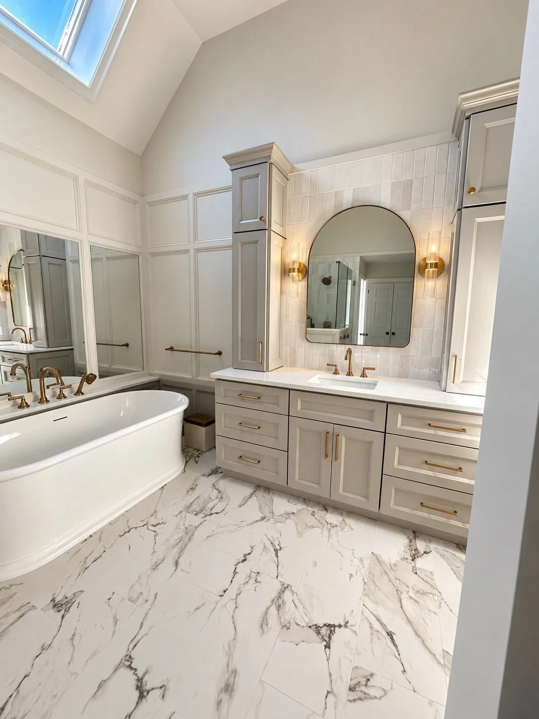 A blend of timeless design and thoughtful detail✨

This Matthews primary bathroom renovation features stunning Calacatta Paonazzo porcelain tile, custom cabinetry, warm gold fixtures, and architectural details that bring the space together. Transform