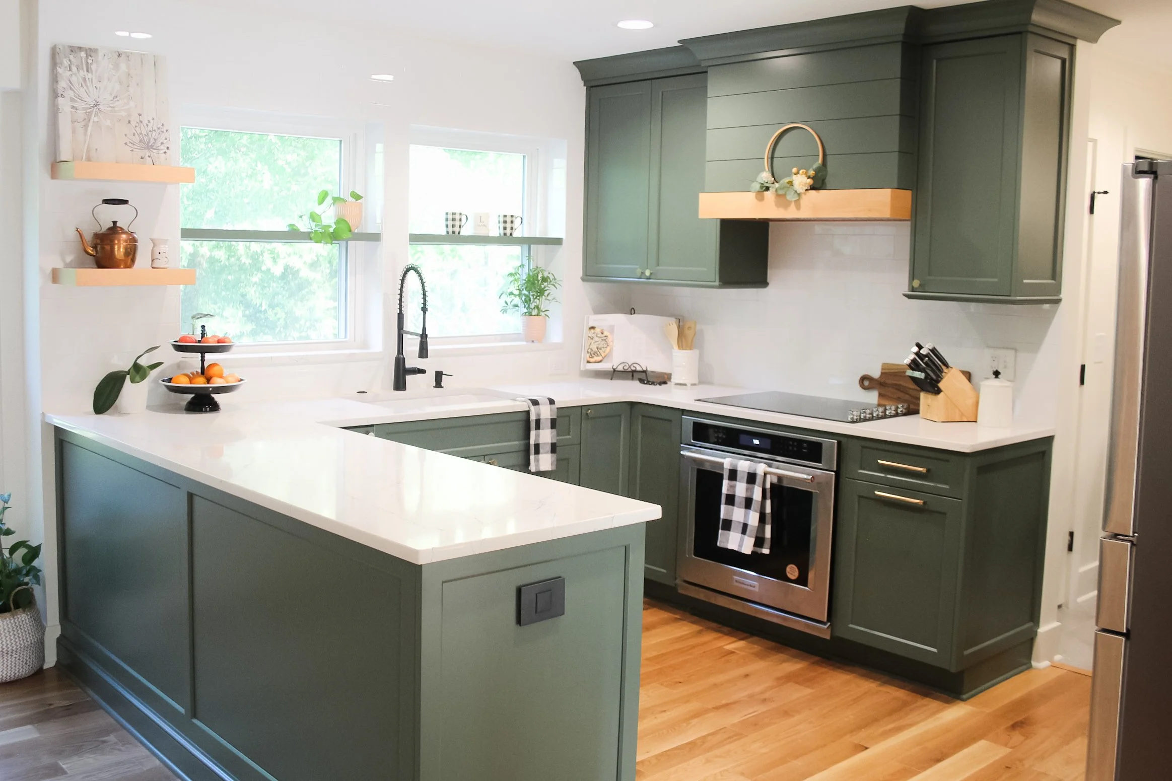 Hunter Green Custom Cabinets, Warm Wood accents, and beautiful white countertops makes this Matthews kitchen peaceful and inviting.