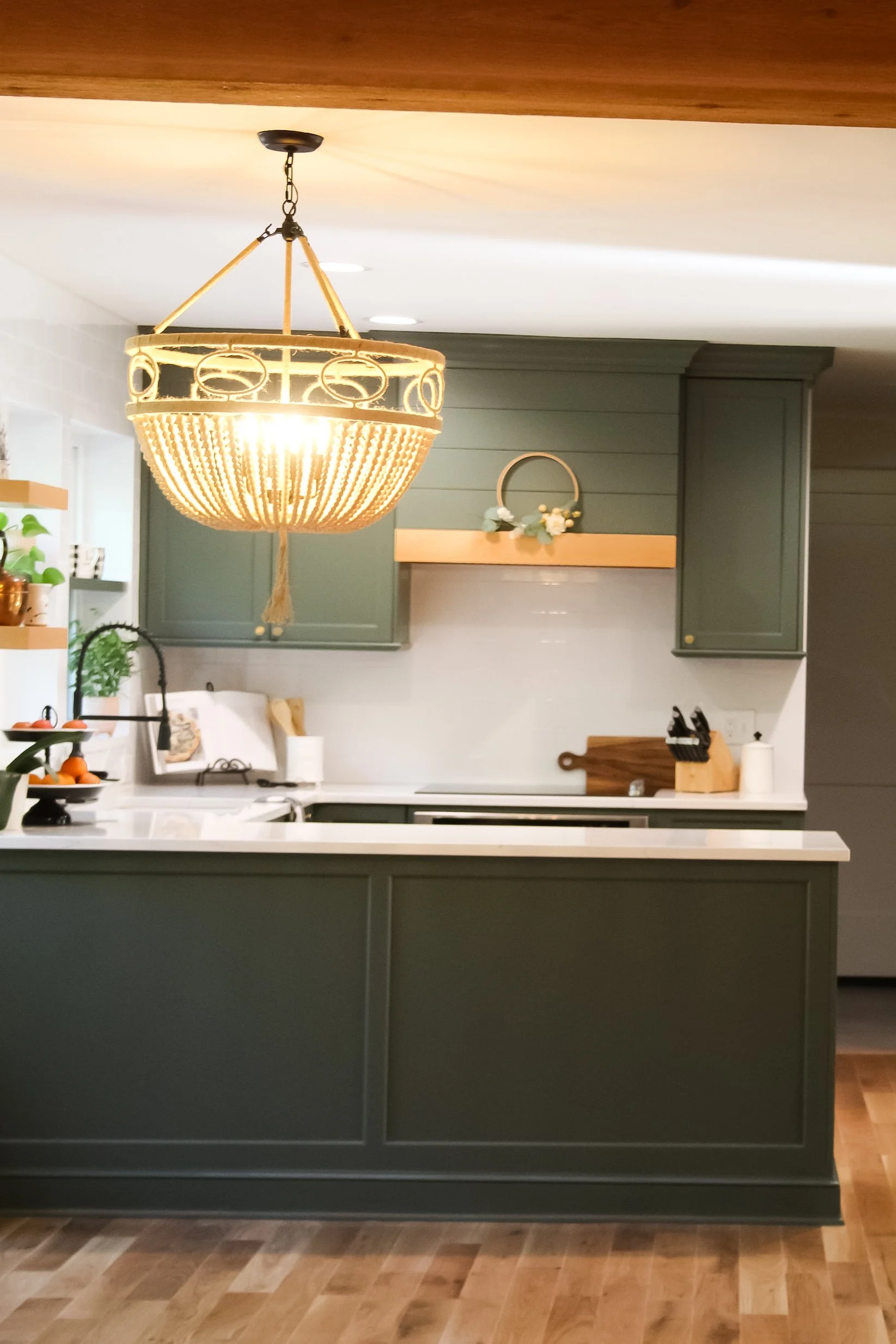 Matthews Kitchen Renovation with soft lighting and warm green custom cabinets