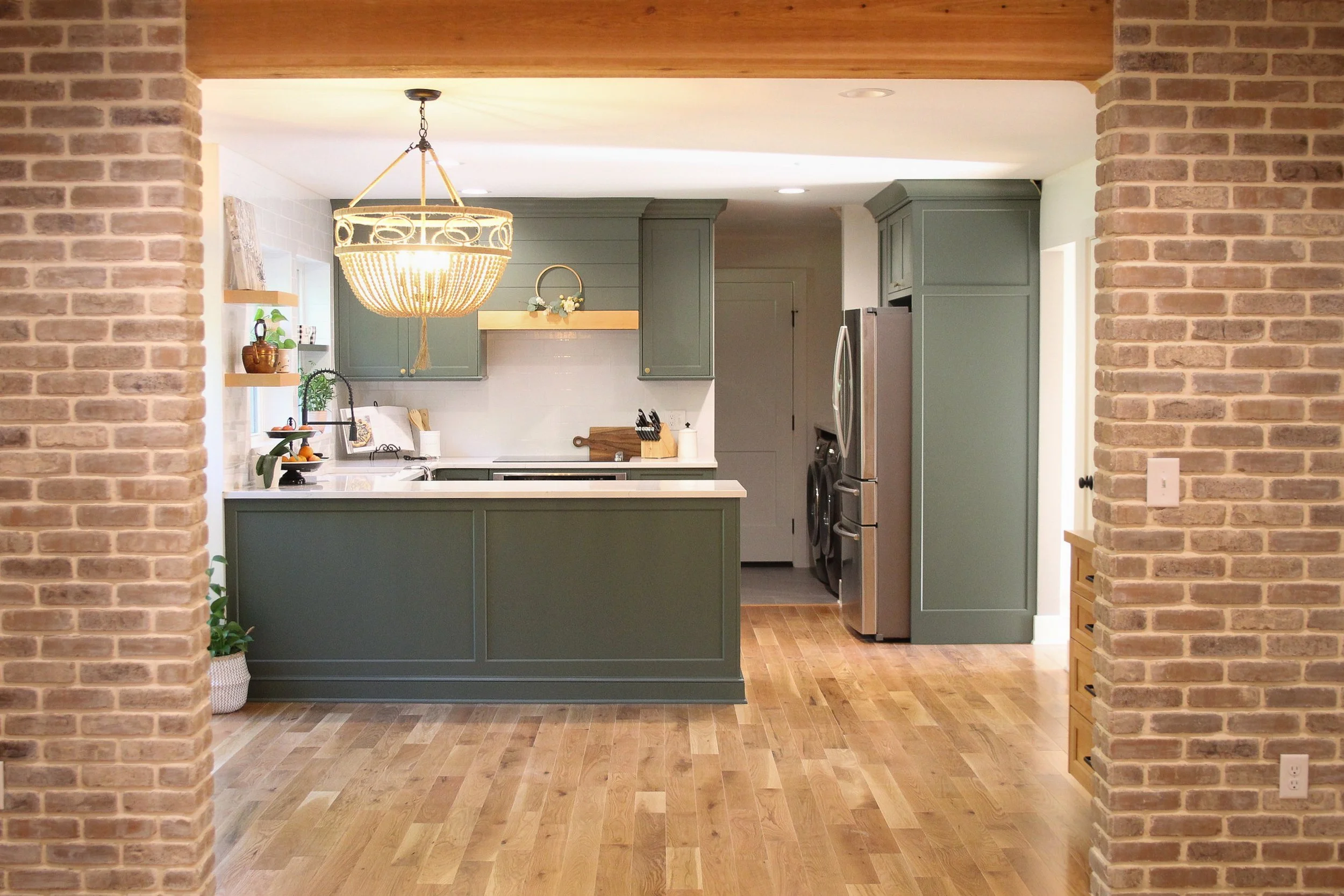 Matthews Kitchen Renovation with soft lighting and warm green custom cabinets