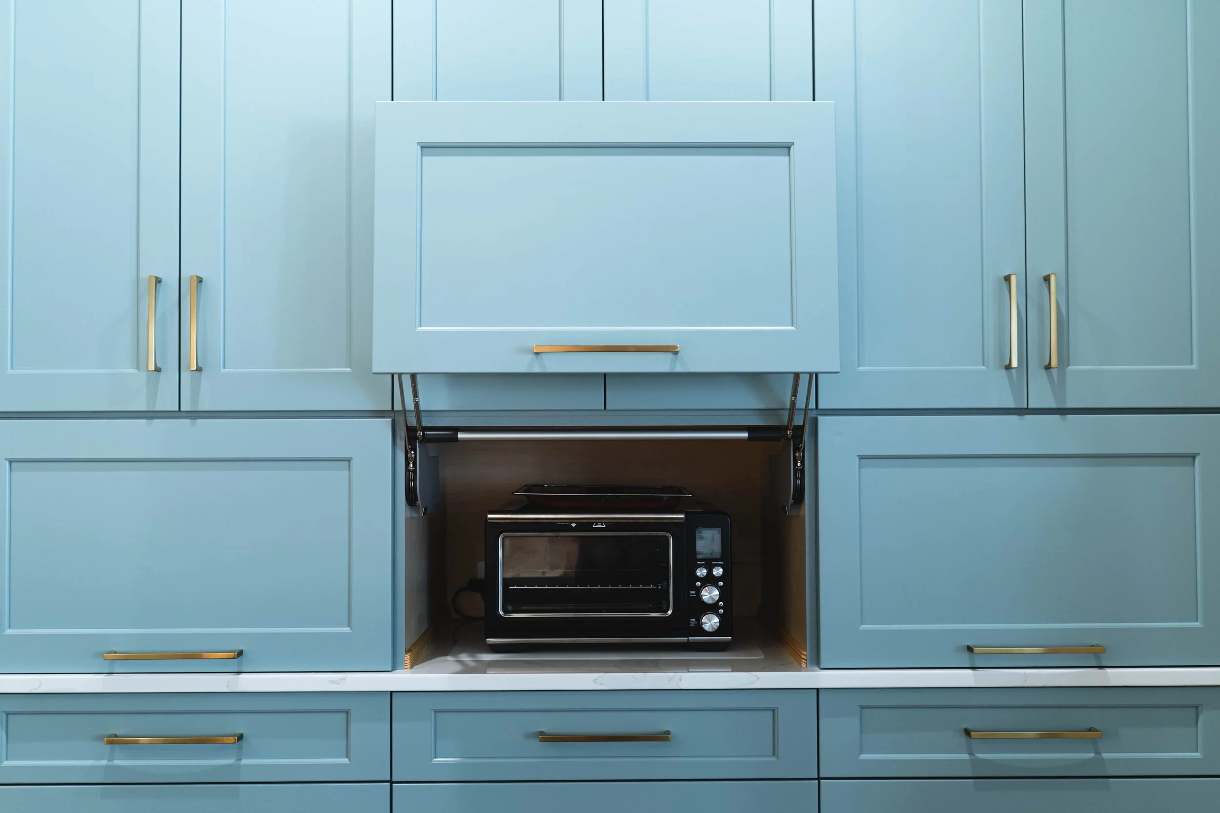 Matthews Kitchen Renovation Highlights custom blue cabinetry with discrete functional storage. Every detail reflects a commitment to thoughtful, everyday living.