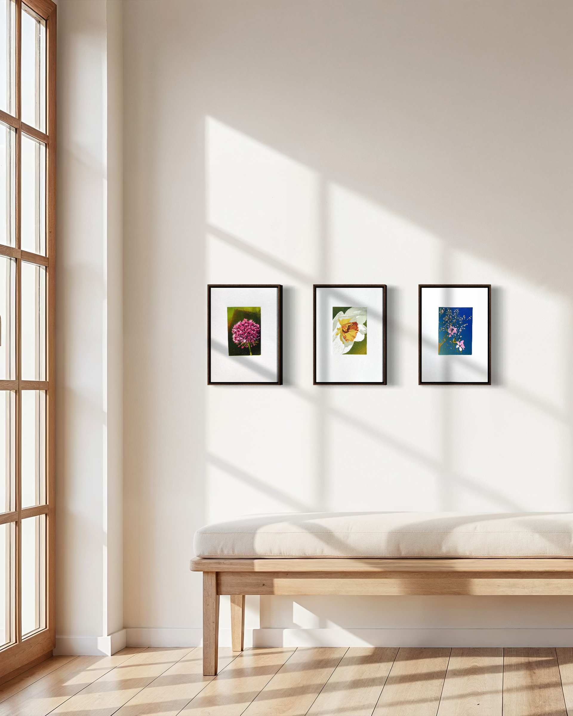 Framed botanical linocut prints featuring colorful flowers arranged on a white wall