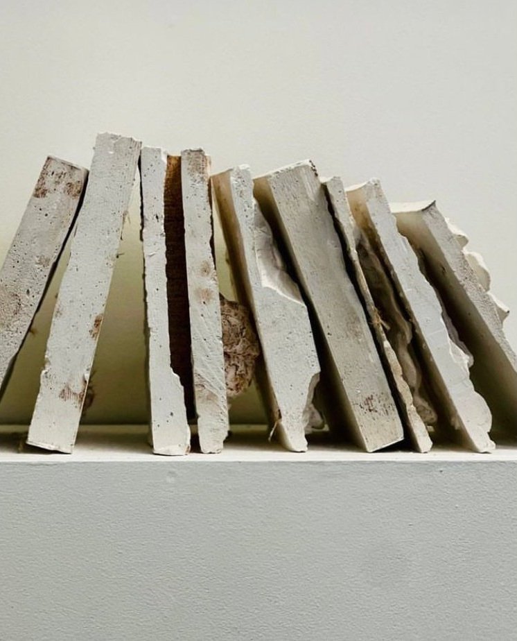 books cast in plaster leaning against each other