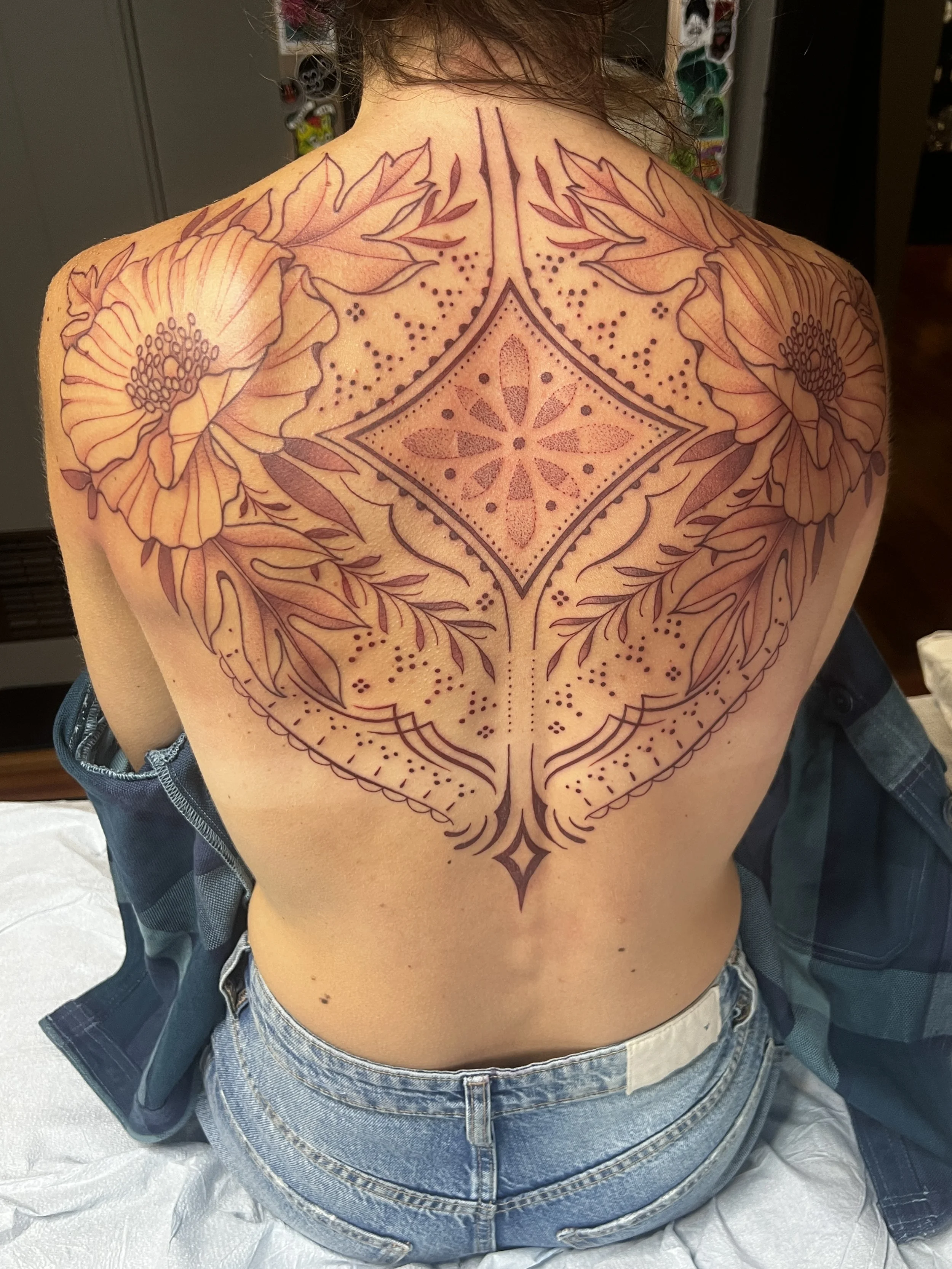 Brown ink ornamental floral tattoo with dotwork and bold lines, designed and tattooed by Maya Wild at Sub Rosa Tattoo Studio in Grants Pass, Oregon. This intricate piece highlights symmetry and complex details. Ideal for clients looking for feminine,