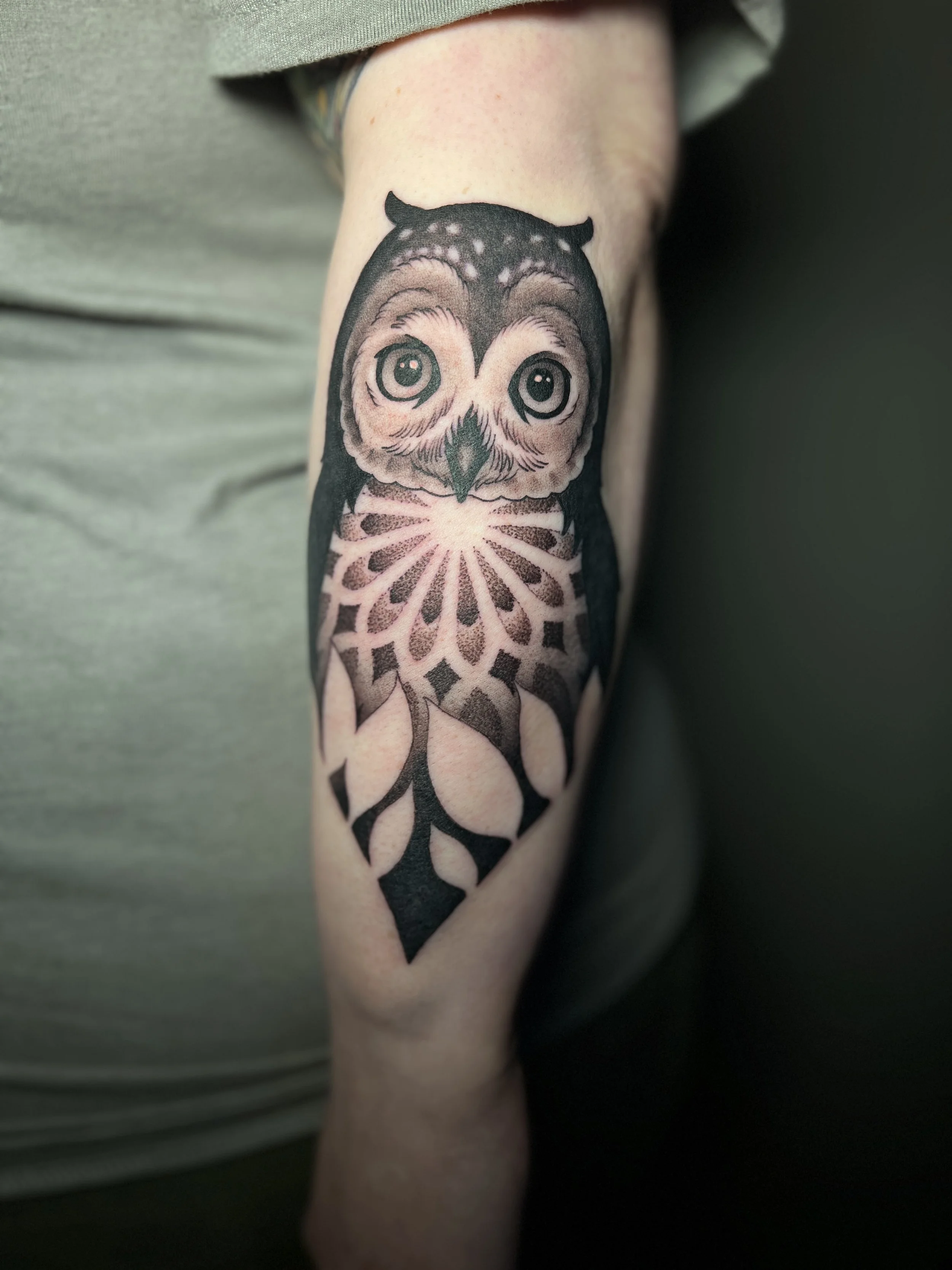 Mandala owl arm tattoo with ornamental and dotwork elements, designed and tattooed by Maya Wild at Sub Rosa Tattoo Studio in Grants Pass, Oregon. This unique piece highlights negative space and bold contrast. Ideal for clients looking for bold yet fe