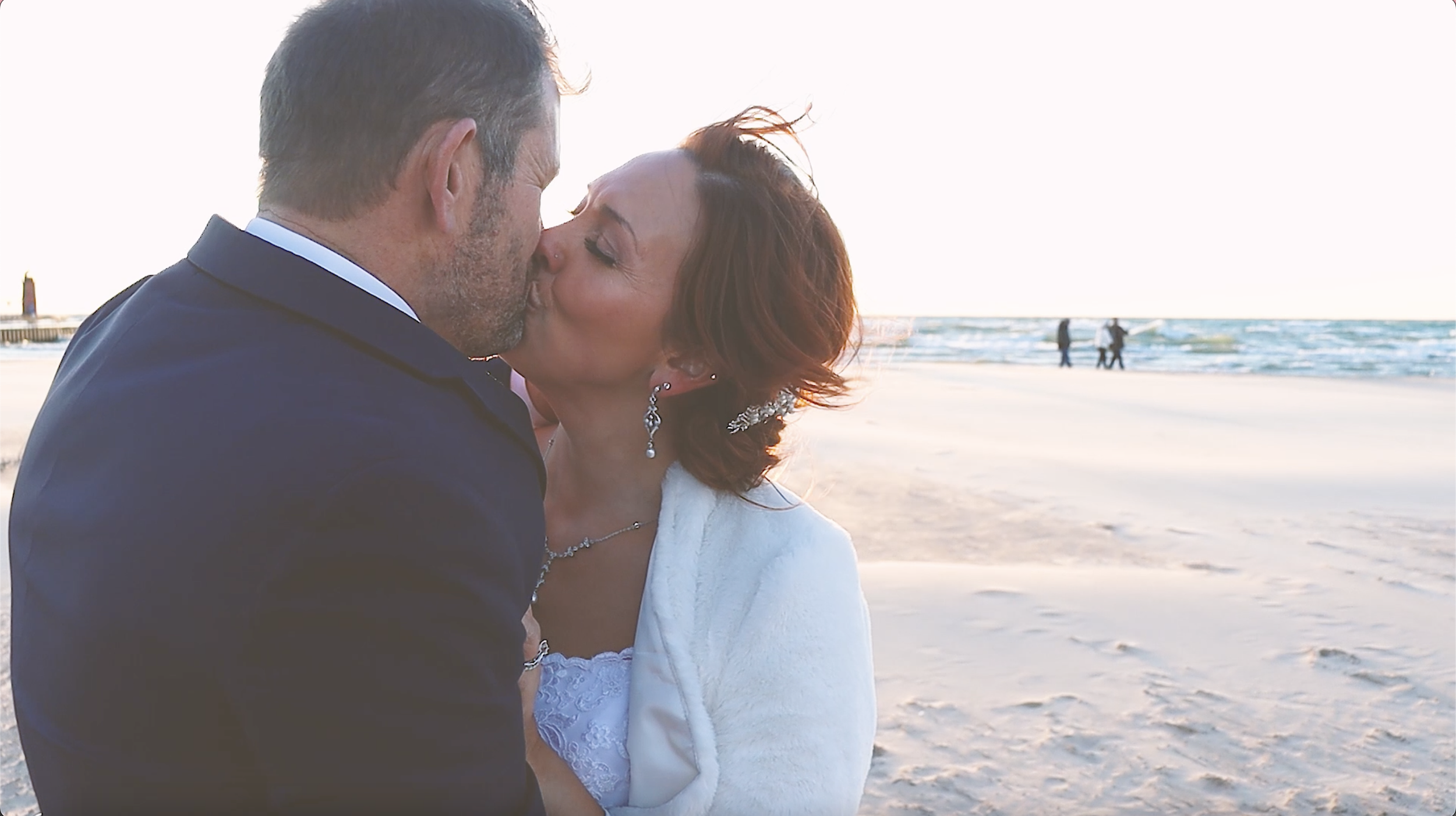 Bride and Groom kissing on their wedding day on a Lake Michigan beach