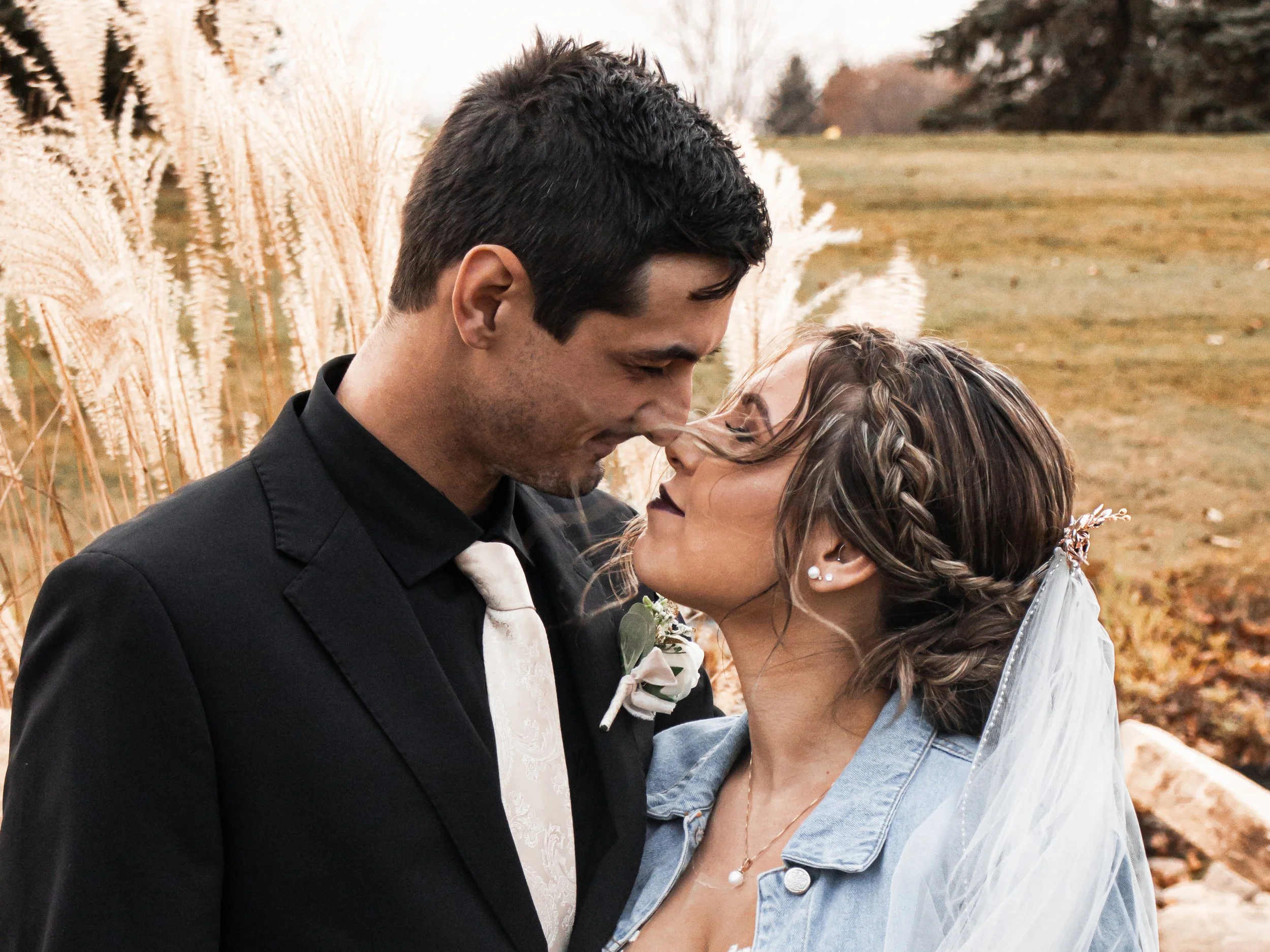 Bride and Groom kissing on the golf field for their autumn wedding in Michigan