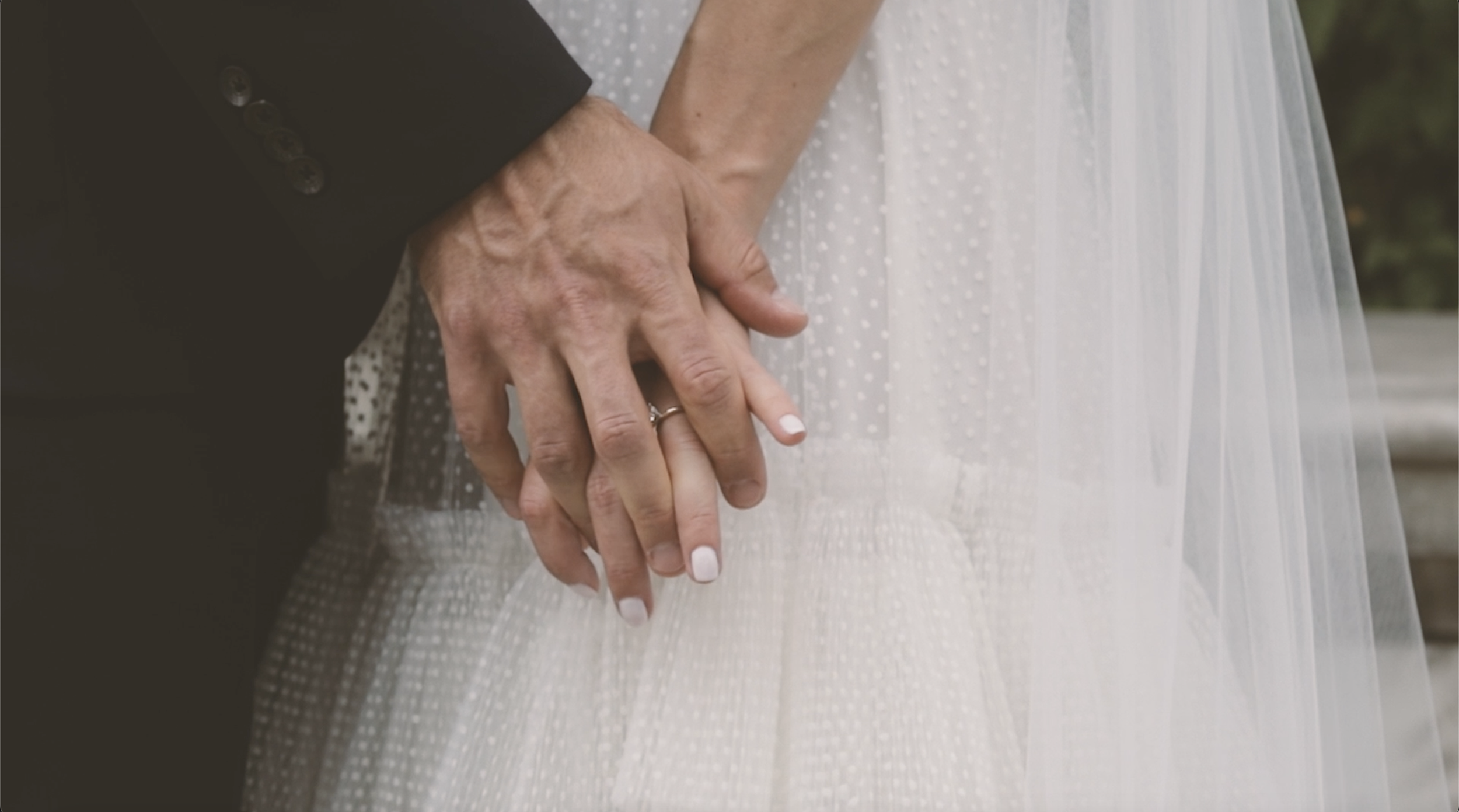 Bridal portrait of couple's hands in a detail shot with wedding ring