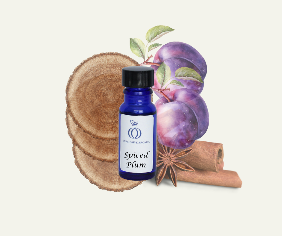 Blue “Spiced Plum” fragrance bottle from Expressive Aromas surrounded by ripe plums, star anise, cinnamon sticks, and woodsy elements.