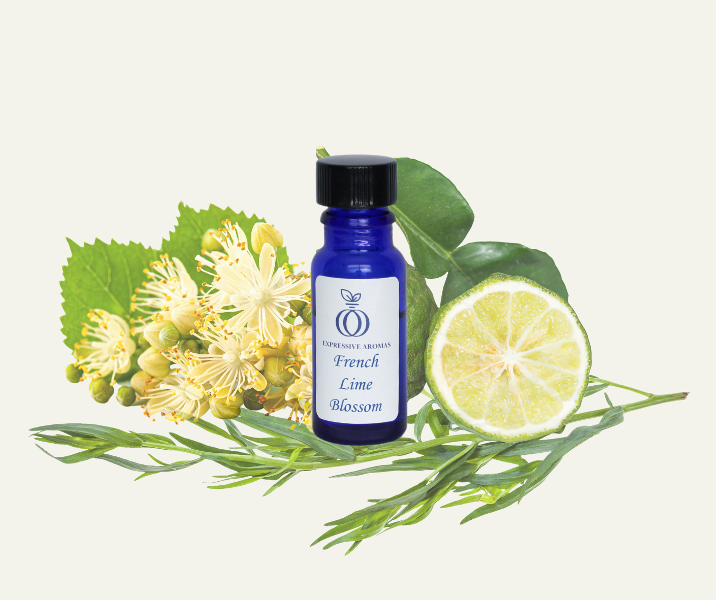 Blue bottle labeled 'French Lime Blossom' surrounded by lemon half, lime leaves, lemon blossoms, and sprigs of herbs on a light background.