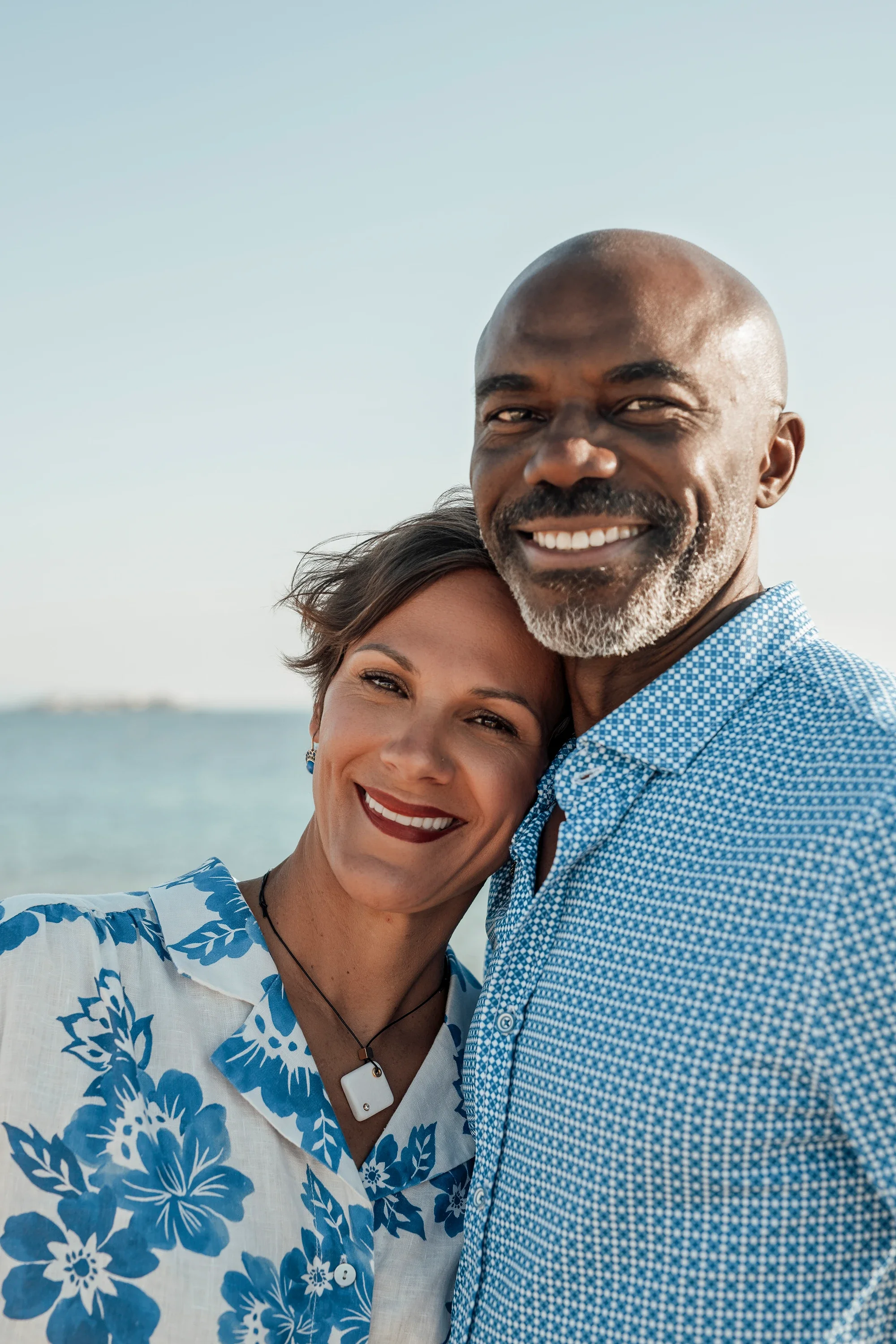 Close up portrait of a smiling couple by the sea in Naxos