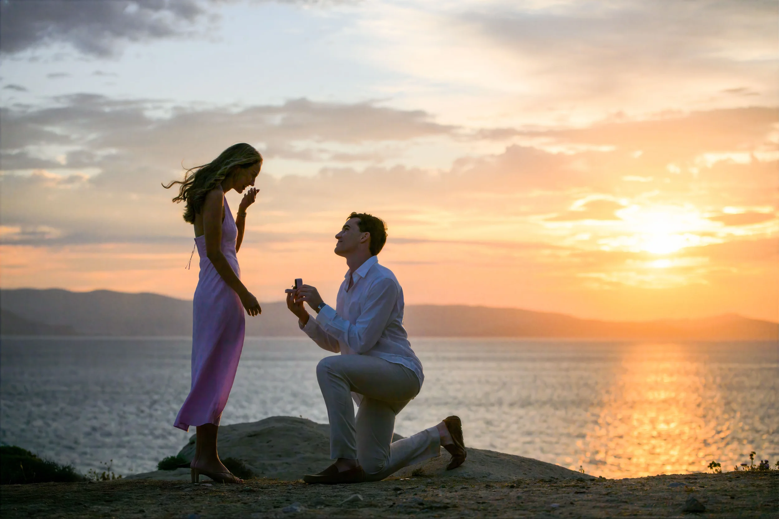 Romantic surprise wedding proposal in Naxos, Greece, photographed at sunset by Naxos Photographer, Spyros Plakidas, with the Aegean Sea in the background.