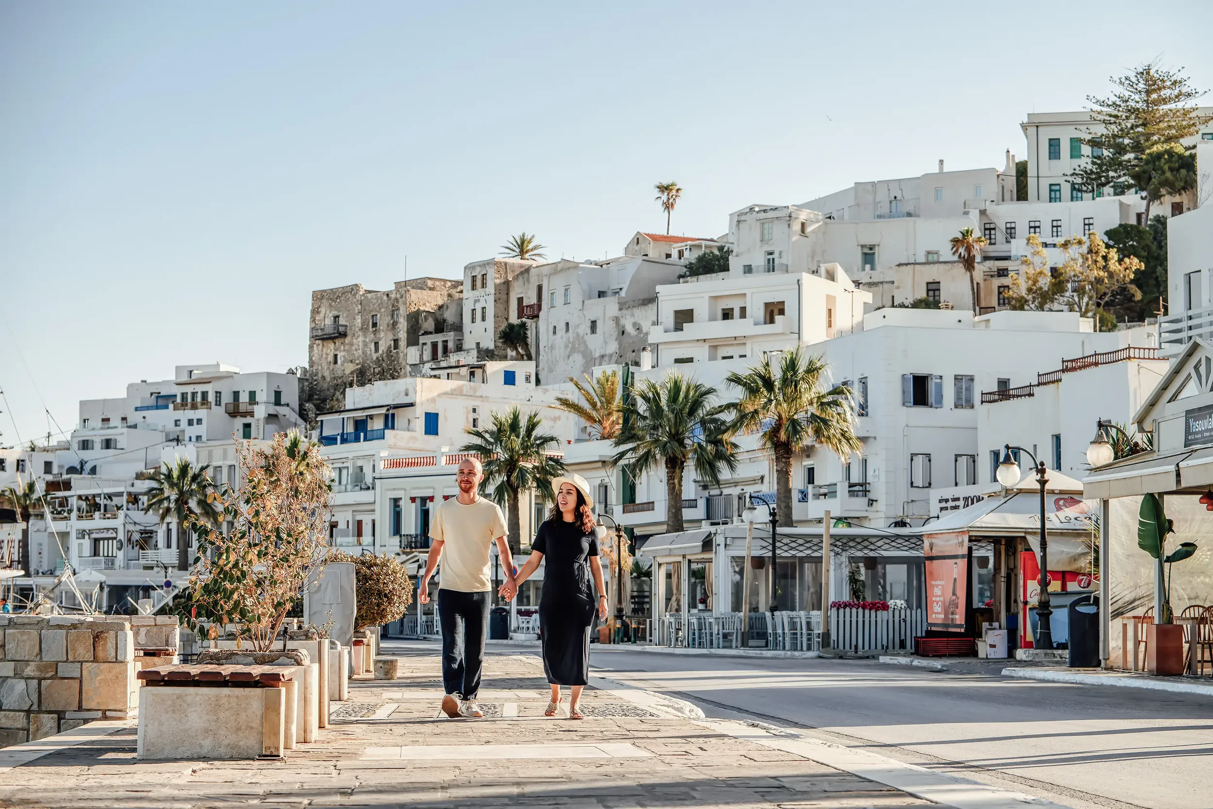 Romantic couples photoshoot in Naxos Old Town, Greece, captured by Naxos Photographer, Spyros Plakidas, with the Venetian Castle and white Cycladic houses in the background.