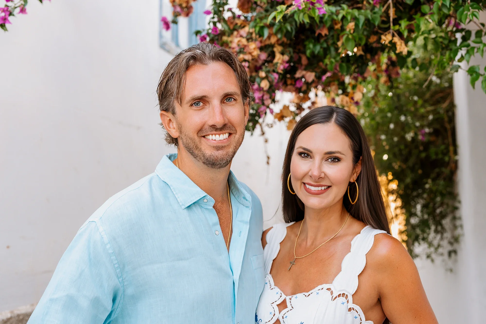Smiling couple portrait with pink bougainvillea in Naxos Old Town