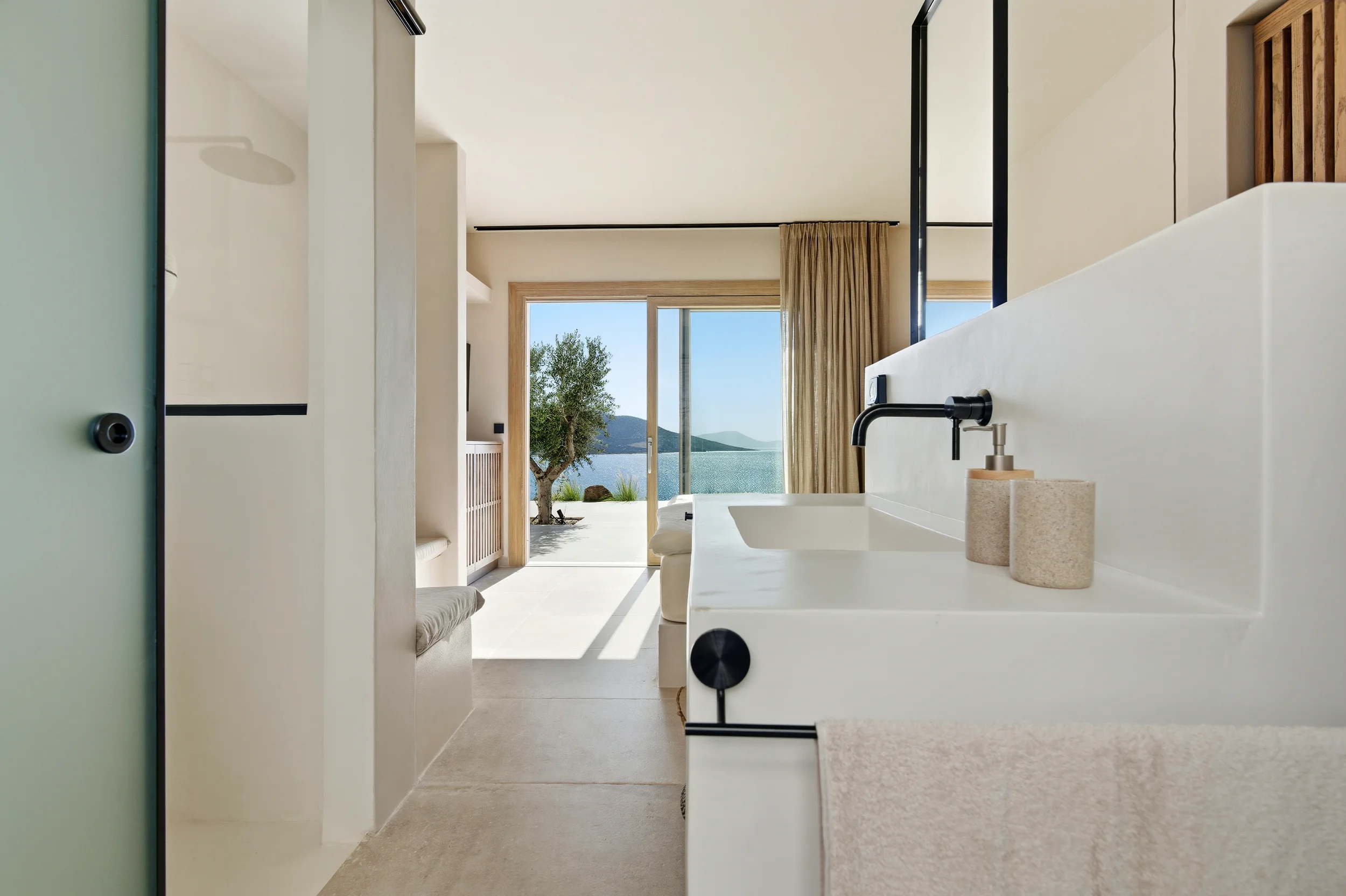 Luxury villa en-suite bathroom with black fixtures, vessel sink and Aegean sea view — real estate photographer Naxos Greece
