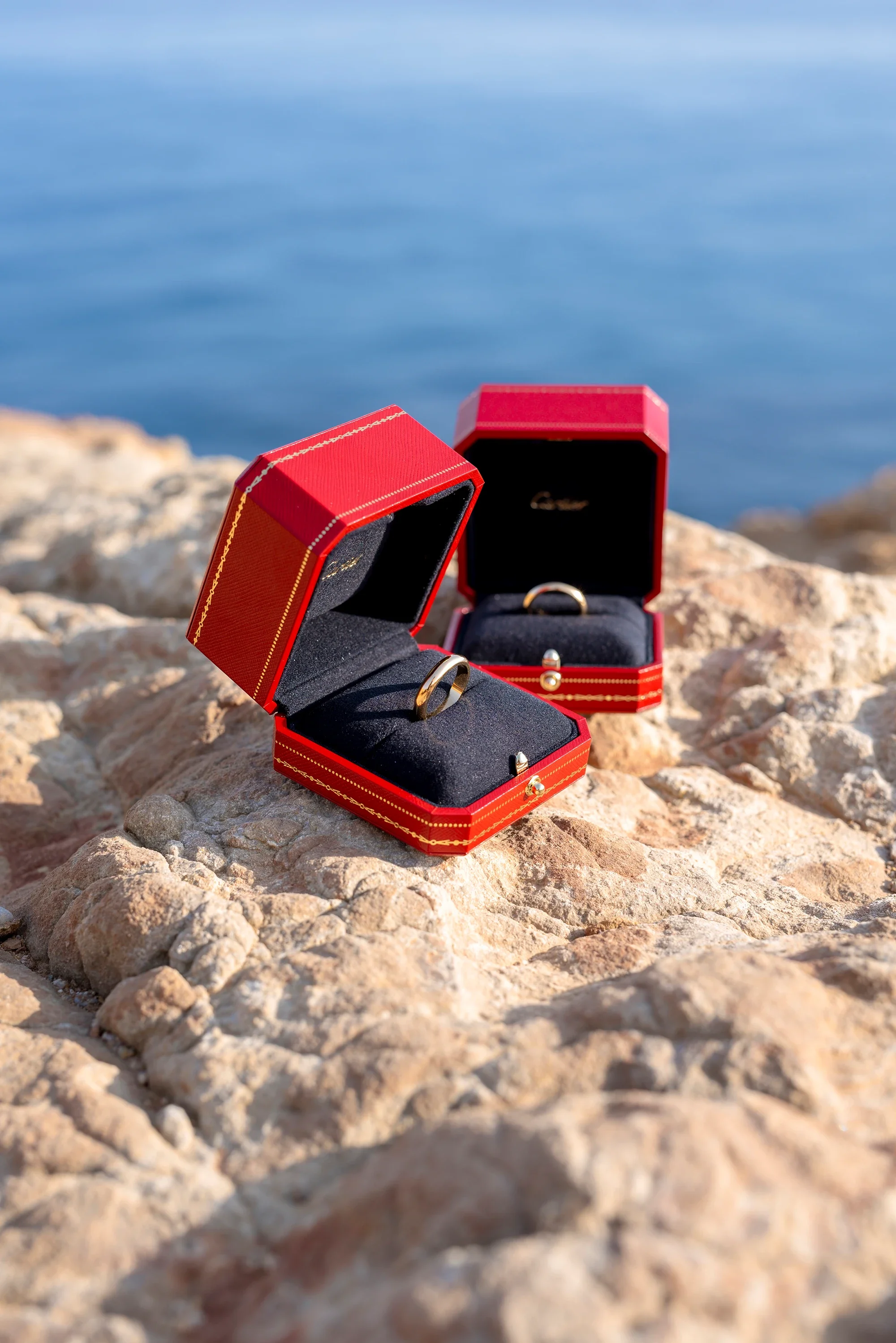Engagement ring boxes resting on coastal rocks in Naxos
