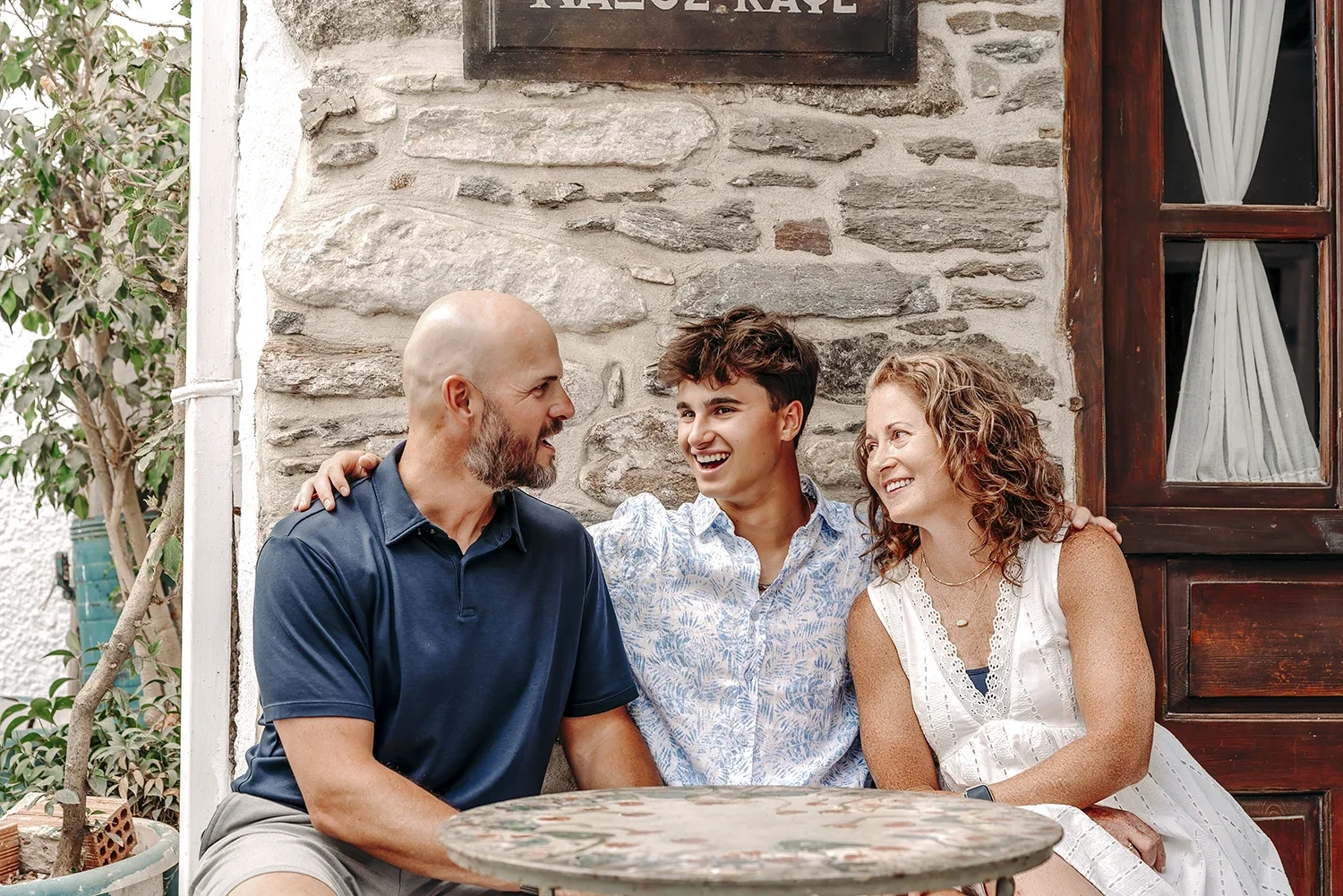 Family of three photographed while having a moment while in the alleys of Naxos Old Town