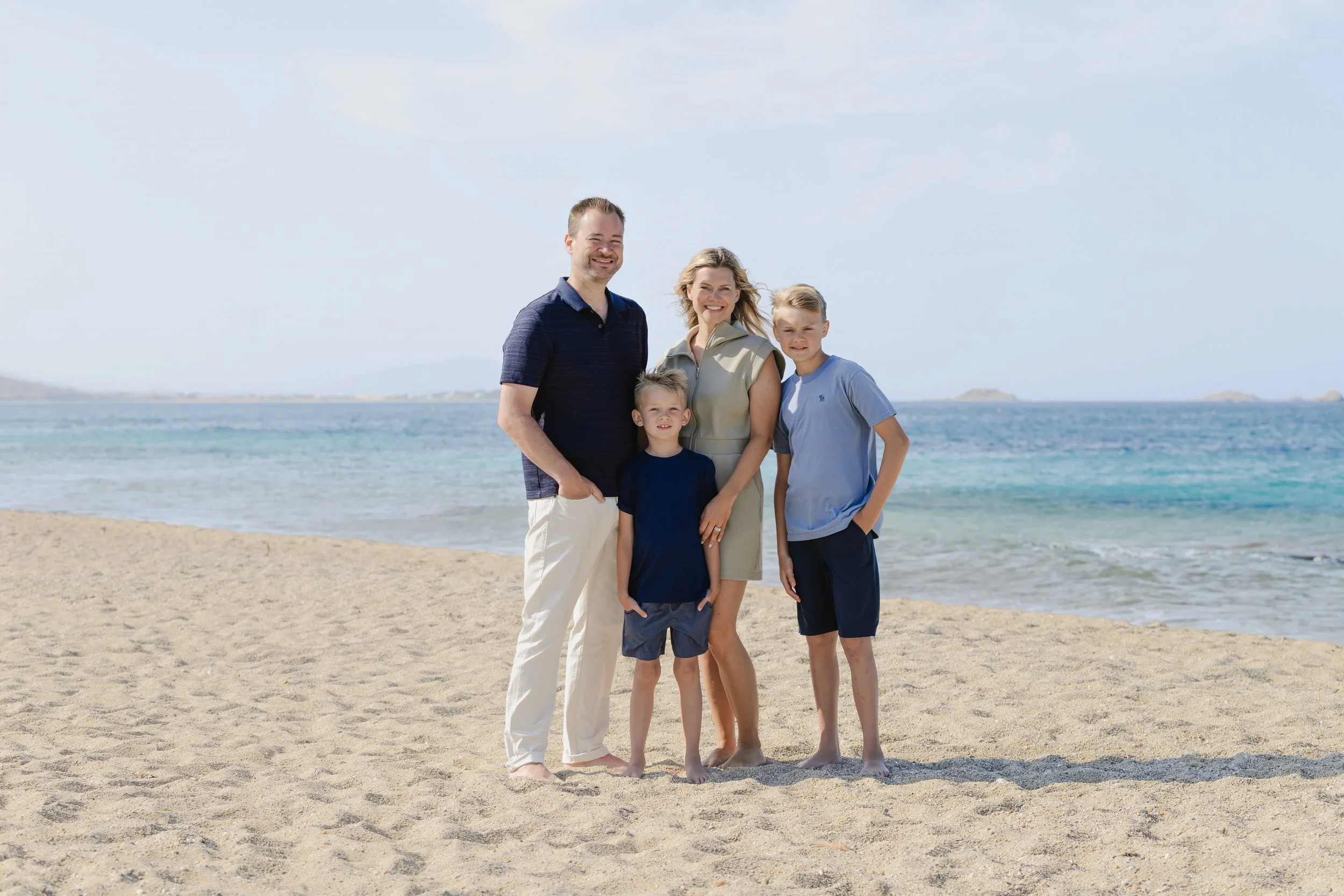 Beach family portrait in Naxos with turquoise Aegean Sea photographed by Naxos Photographer.