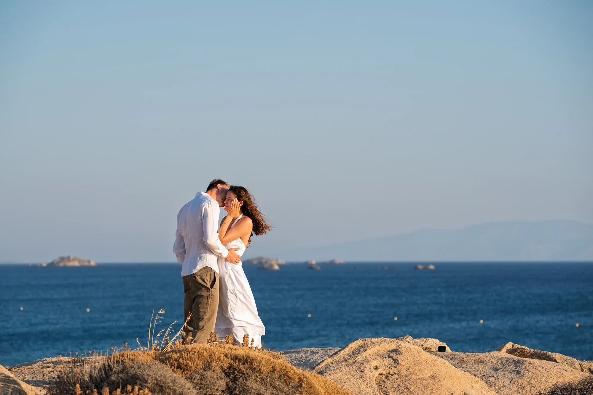 Couple holding each other at sunset in Naxos just after a proposal