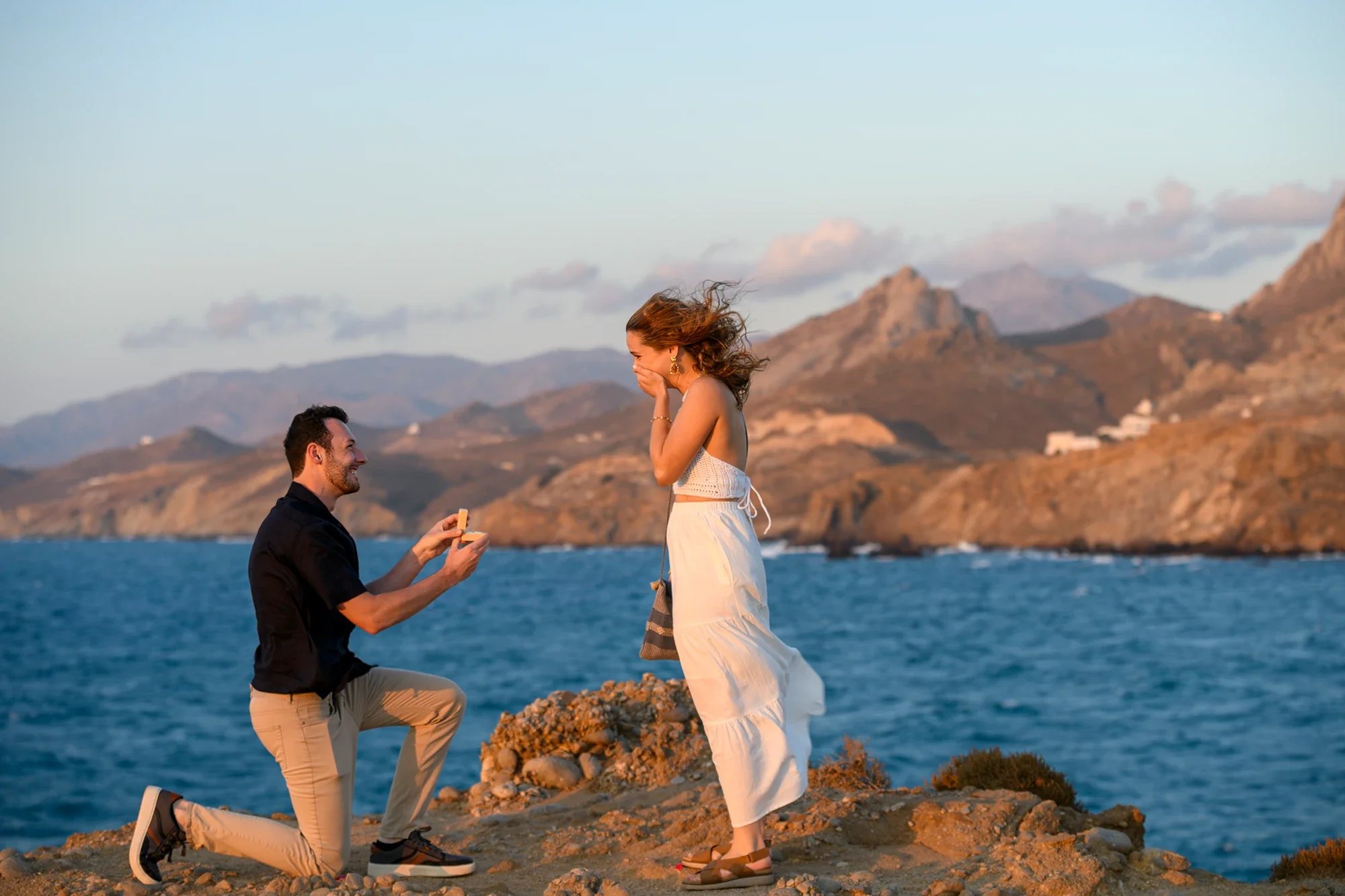 Surprise proposal in Naxos with dramatic coastal mountains in the background
