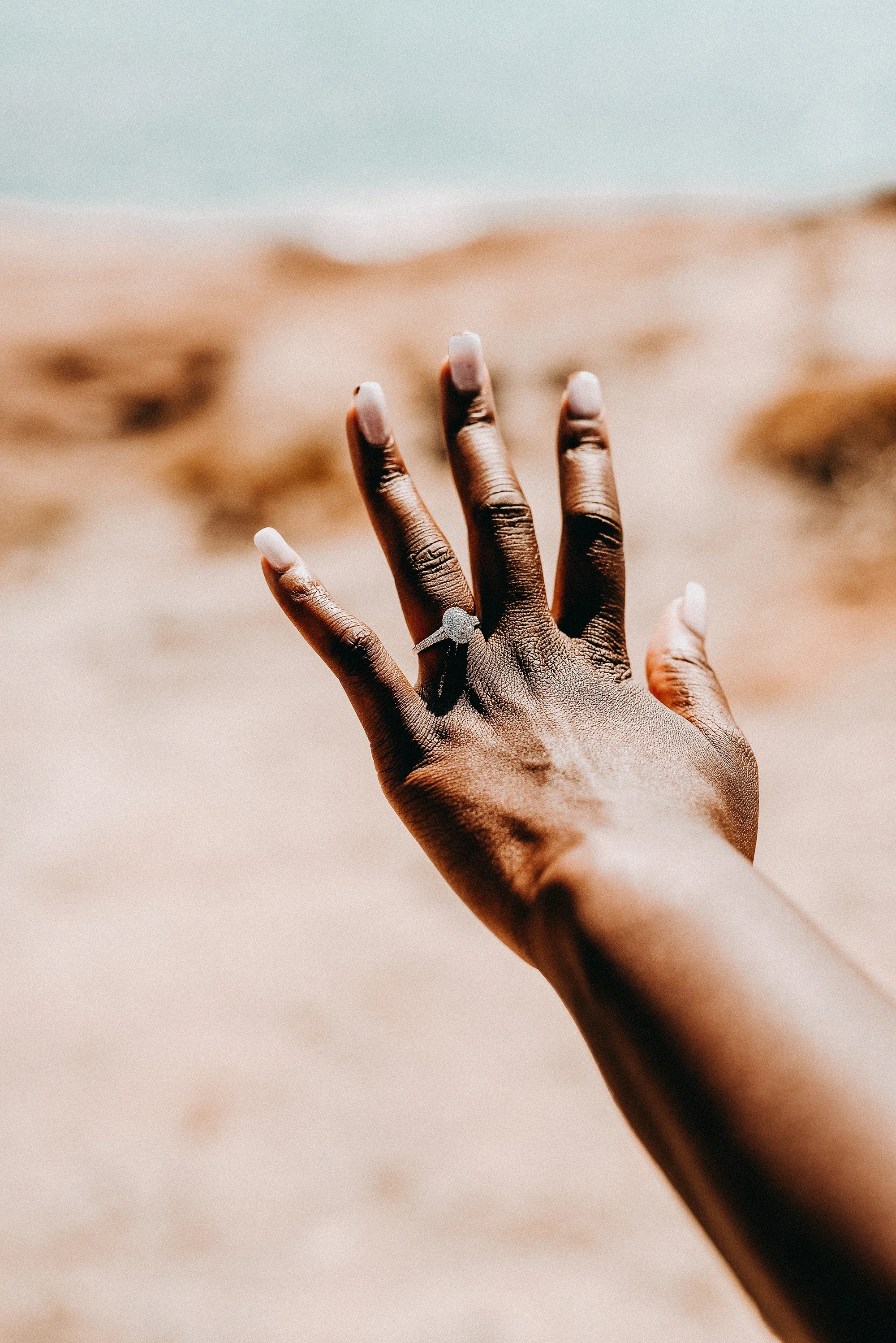 Woman showing her engagement ring after a proposal on a Naxos beach