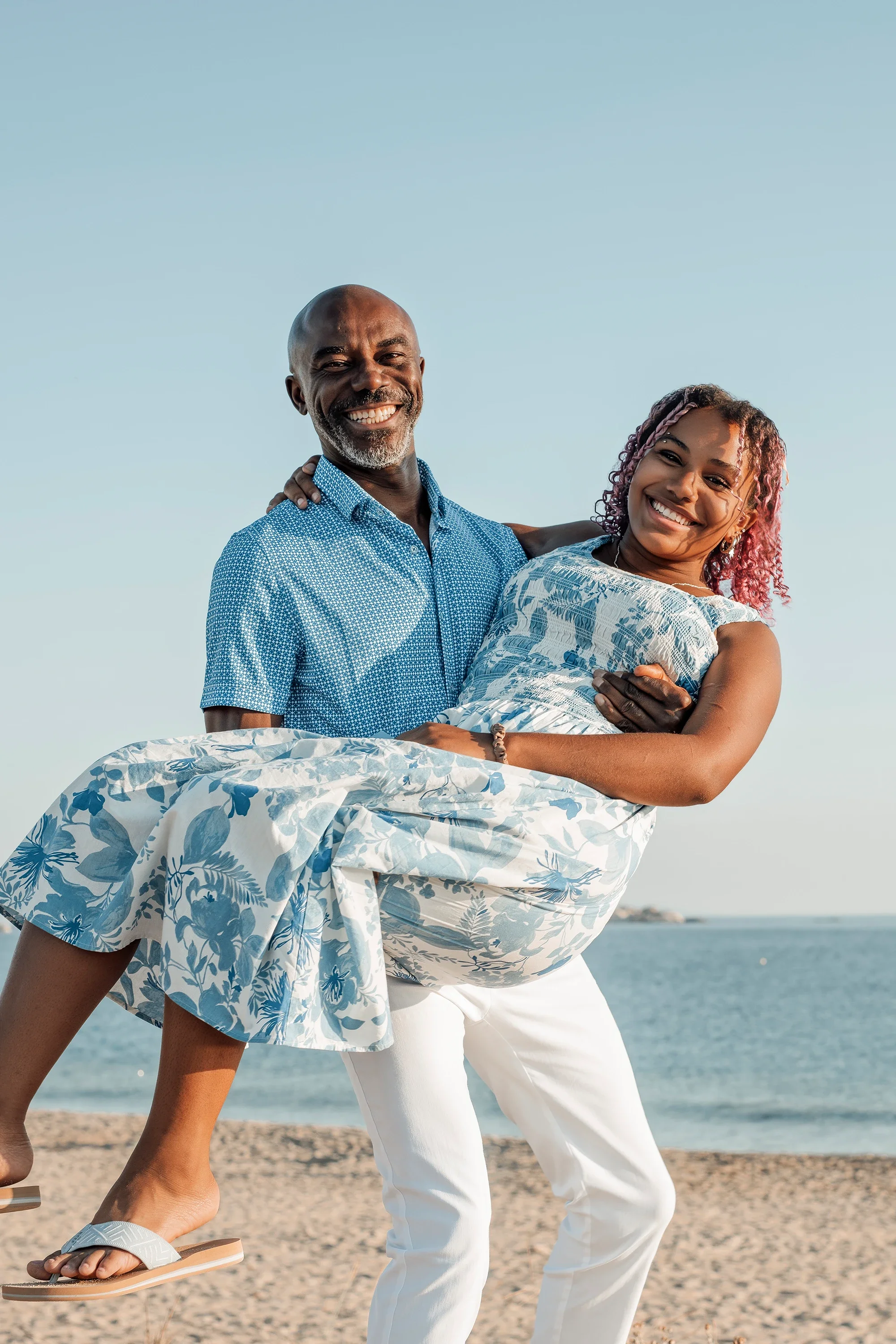 Father and daughter laughing together on a Naxos beach