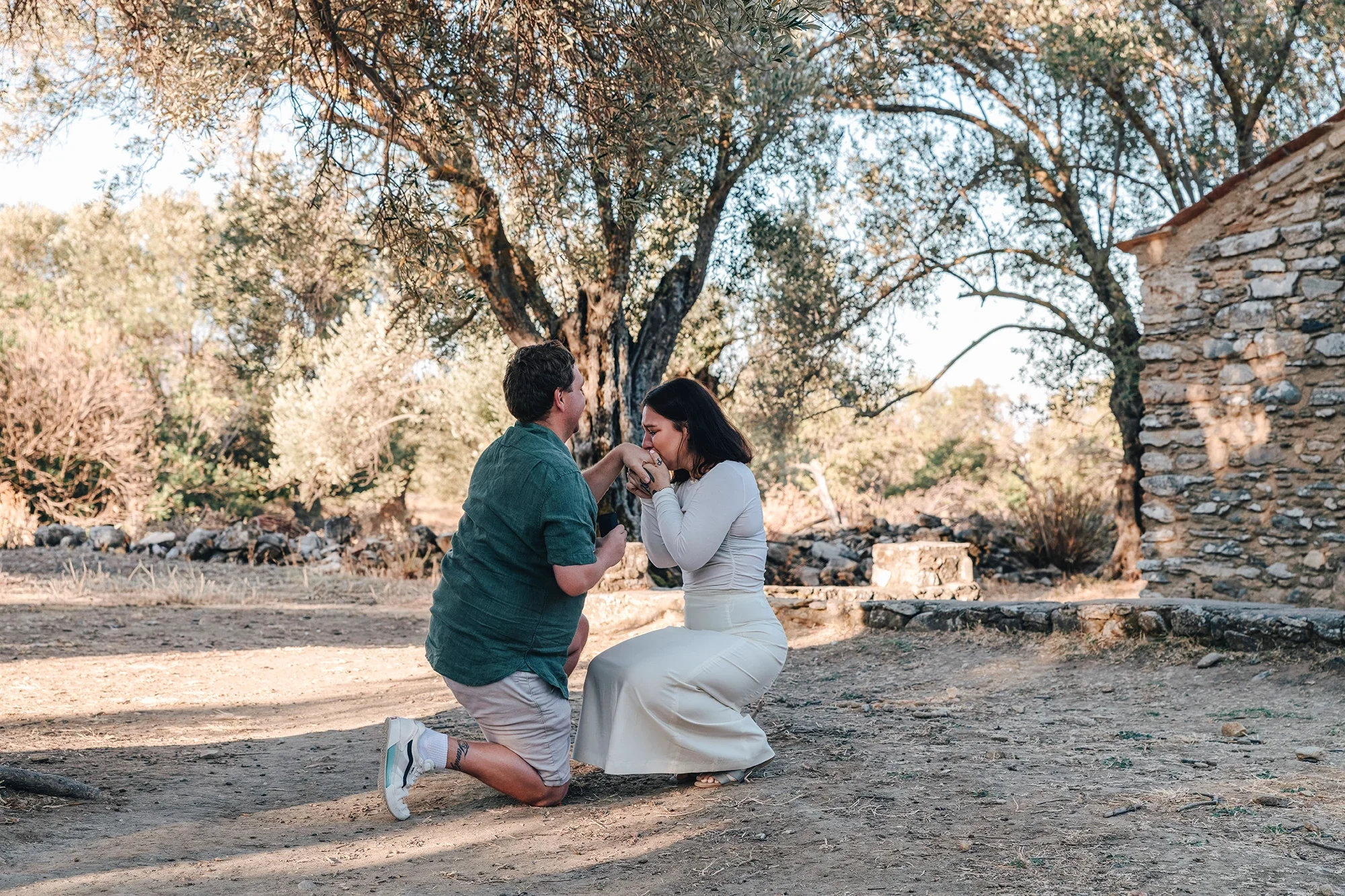 Couple during surprise proposal in an olive grove in Naxos