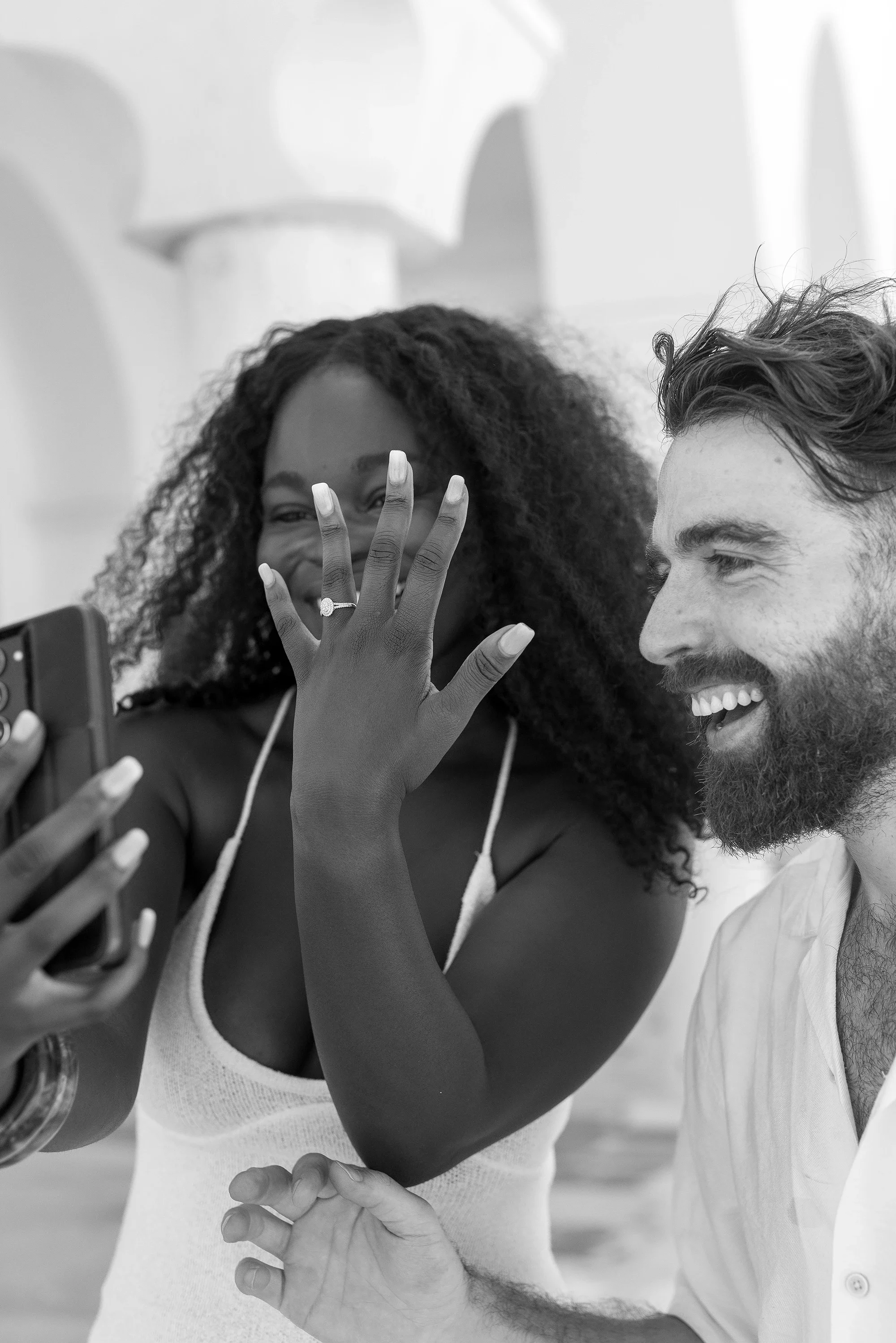 Newly engaged couple sharing the news on a video call in Naxos