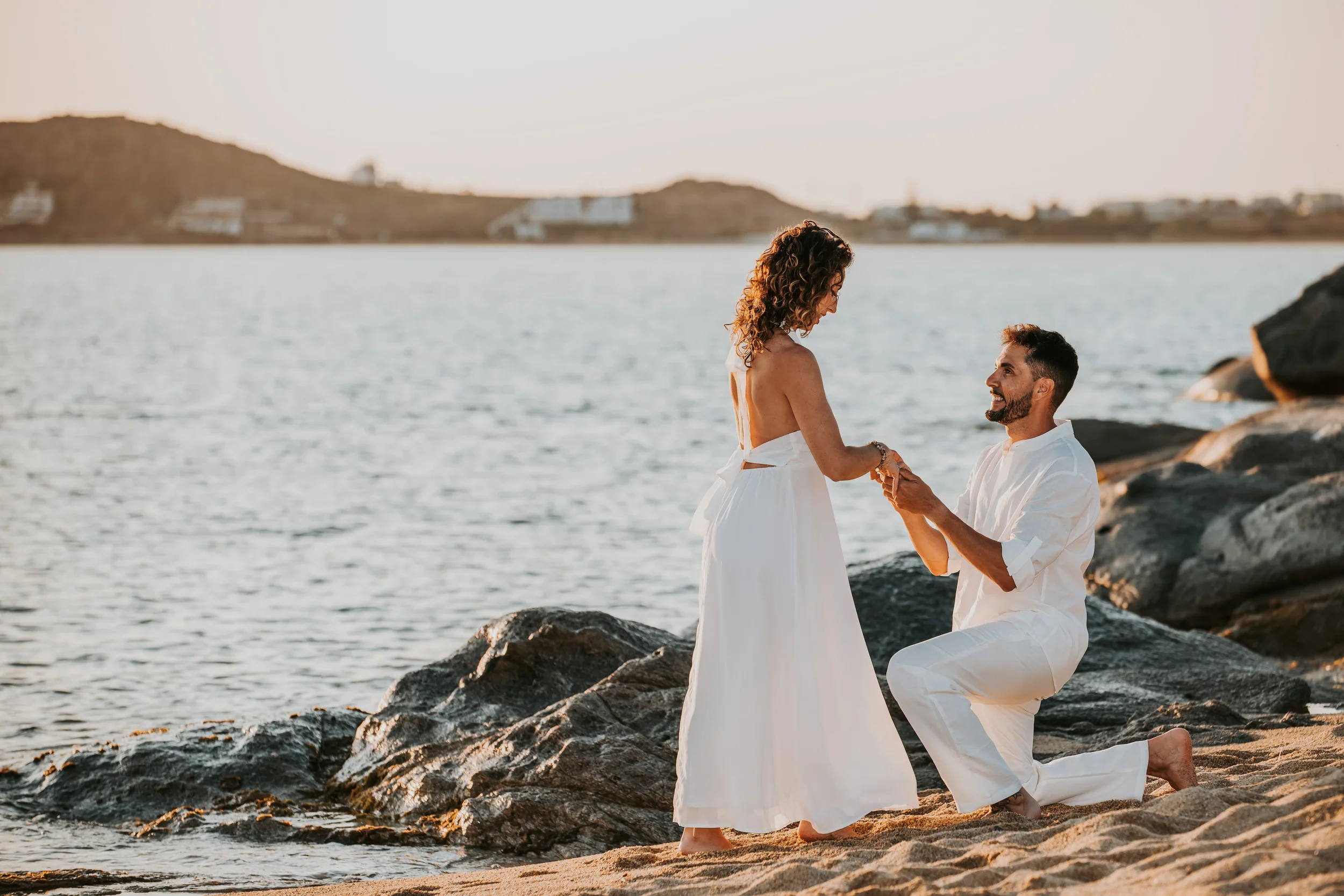 Romantic surprise wedding proposal on a beach in Naxos, Greece, photographed by Naxos Photographer, Spyros Plakidas, during a golden hour engagement session.