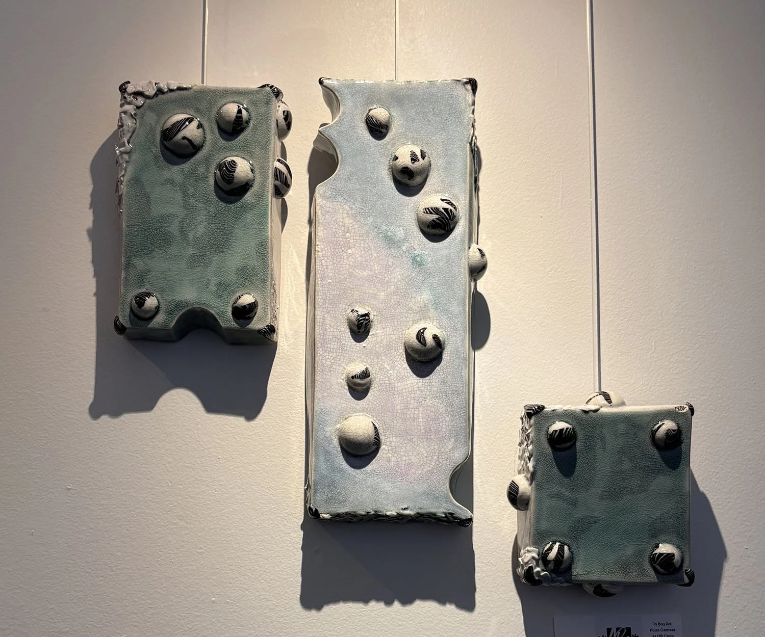 "Cosmic" by Susan Hacker. Ceramic wall sculpture.  $350.