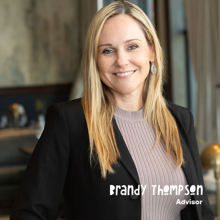 Professional woman with blonde hair in a business suit, smiling.