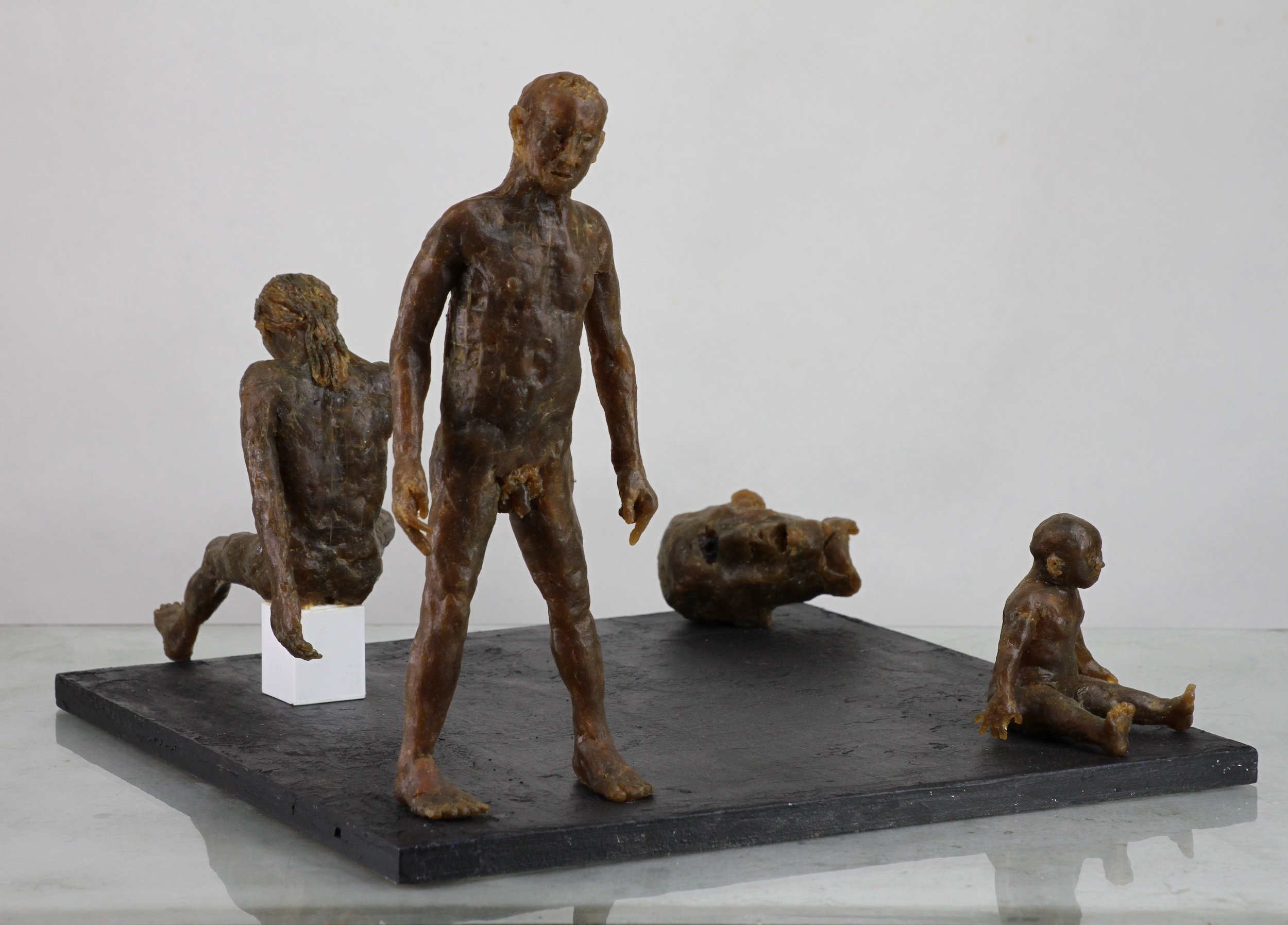 Three Figures, Head (2021-2022), microcrystalline wax, painted wood base, 8 5/8 x 15 1/8 x 14 inches