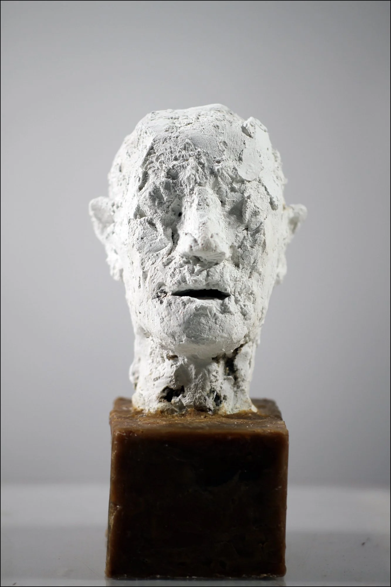 Small Head (2026), Winterstone, microcrystalline wax base, 7 5/8 x 4 ¾ x 4 ½ inches
