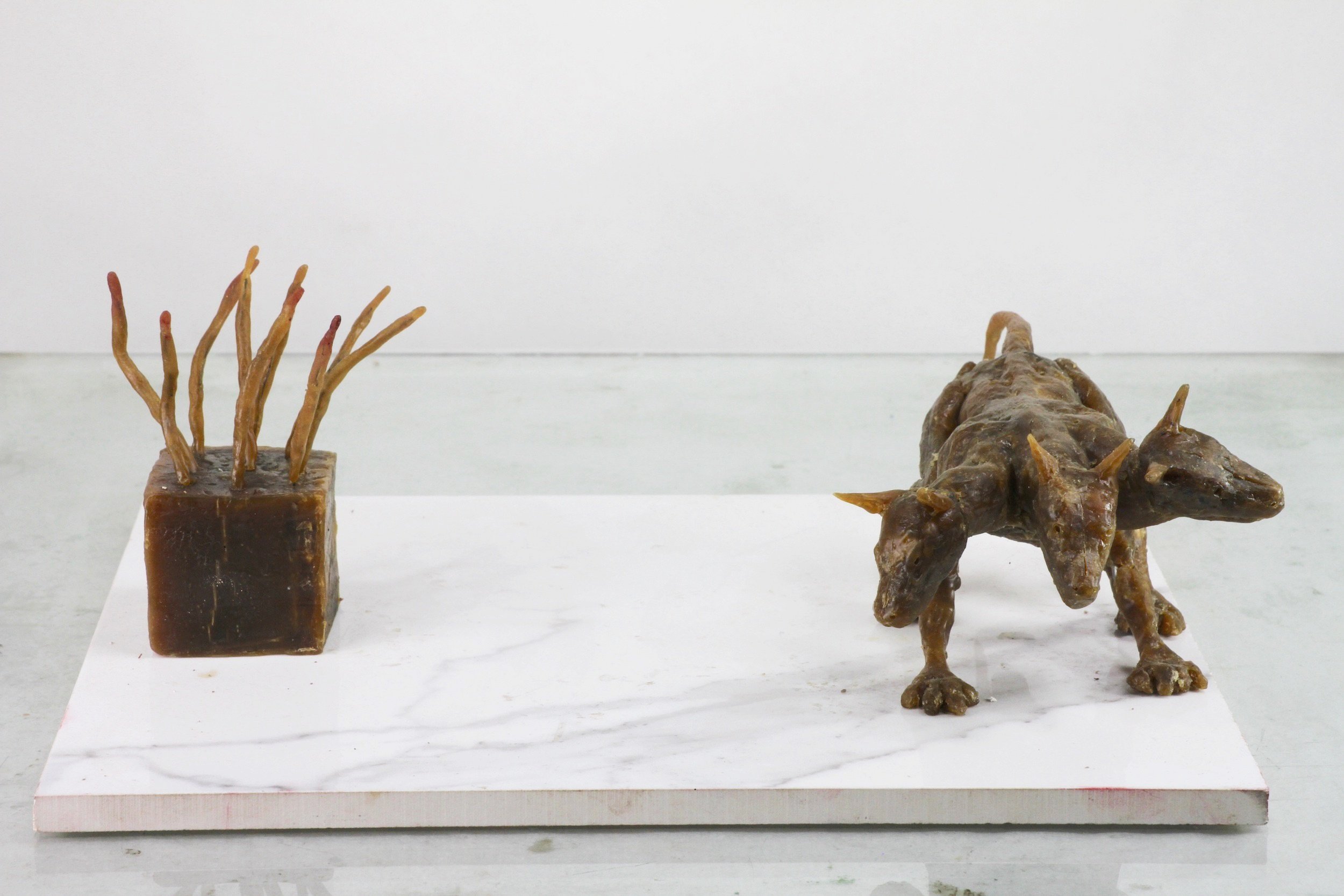 Object, Dog  (2022), microcrystalline wax, ceramic base, 4 x 12 1/8 x 9 3/4 inches 
