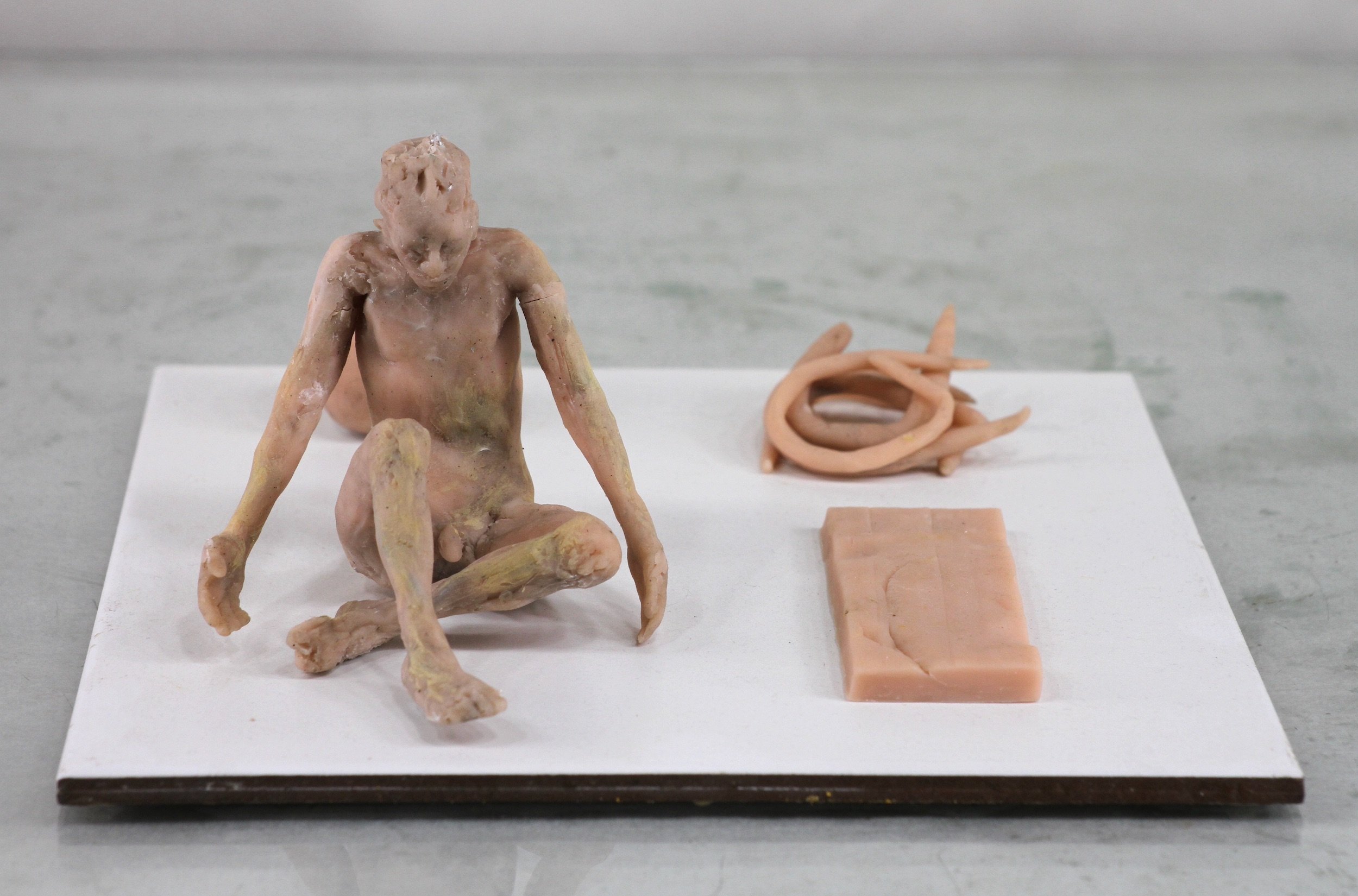 Figure, Slab, Coil, Sphere (2022), polymer clay, ceramic base, 3 3/4 x 7 13/16 x 7 13/16 inches