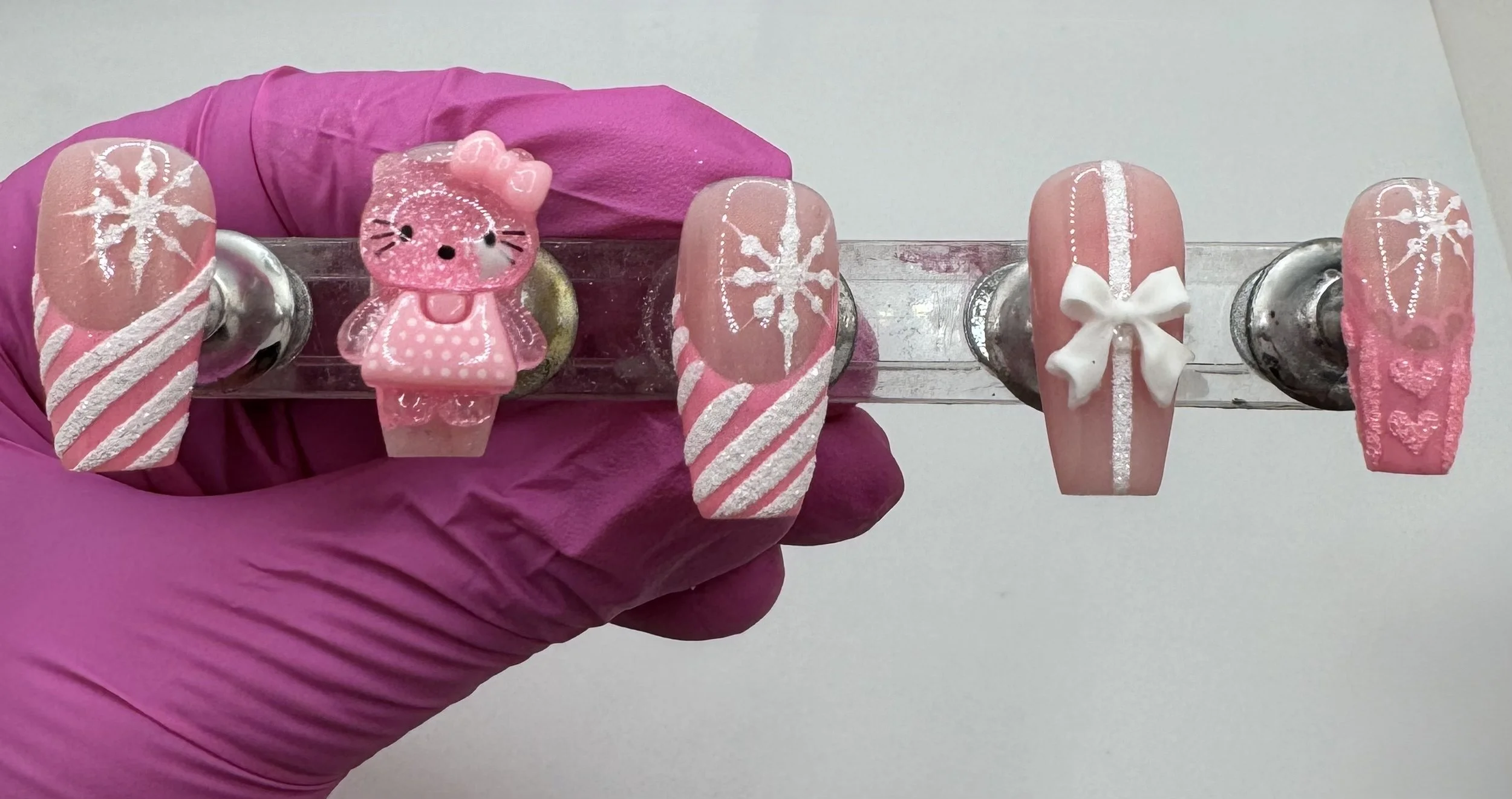 Pink Hello Kitty Christmas 3D French tip press-on nails, showcasing holiday sparkle and festive nail art