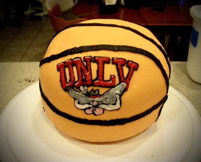 A cake shaped and decorated like a basketball with the Looney Tunes character Bugs Bunny and the word UNLV on it.