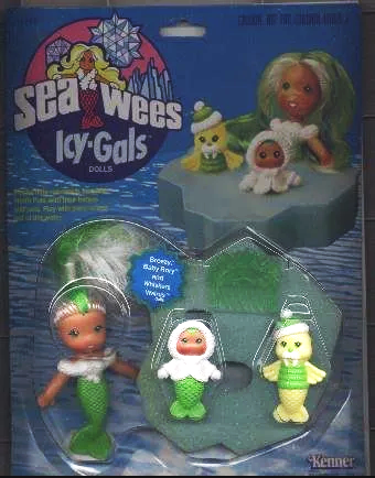 Sea-Wees Ly'Gals dolls in packaging featuring mermaid dolls in green, white, and yellow outfits with seaweed-themed hats, and a large mermaid doll with green hair and red lips in the background.