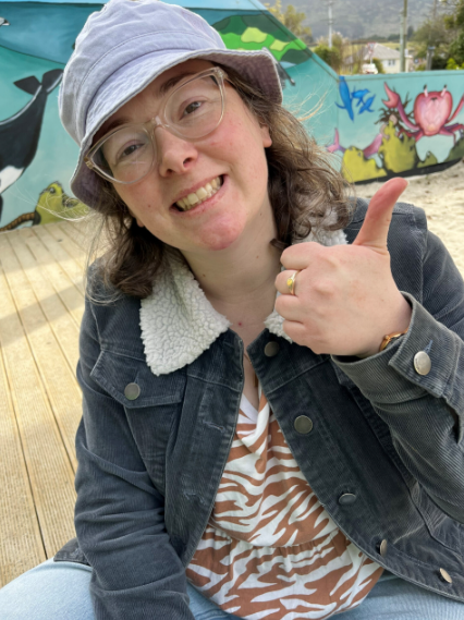 Woman smiling, giving thumbs up